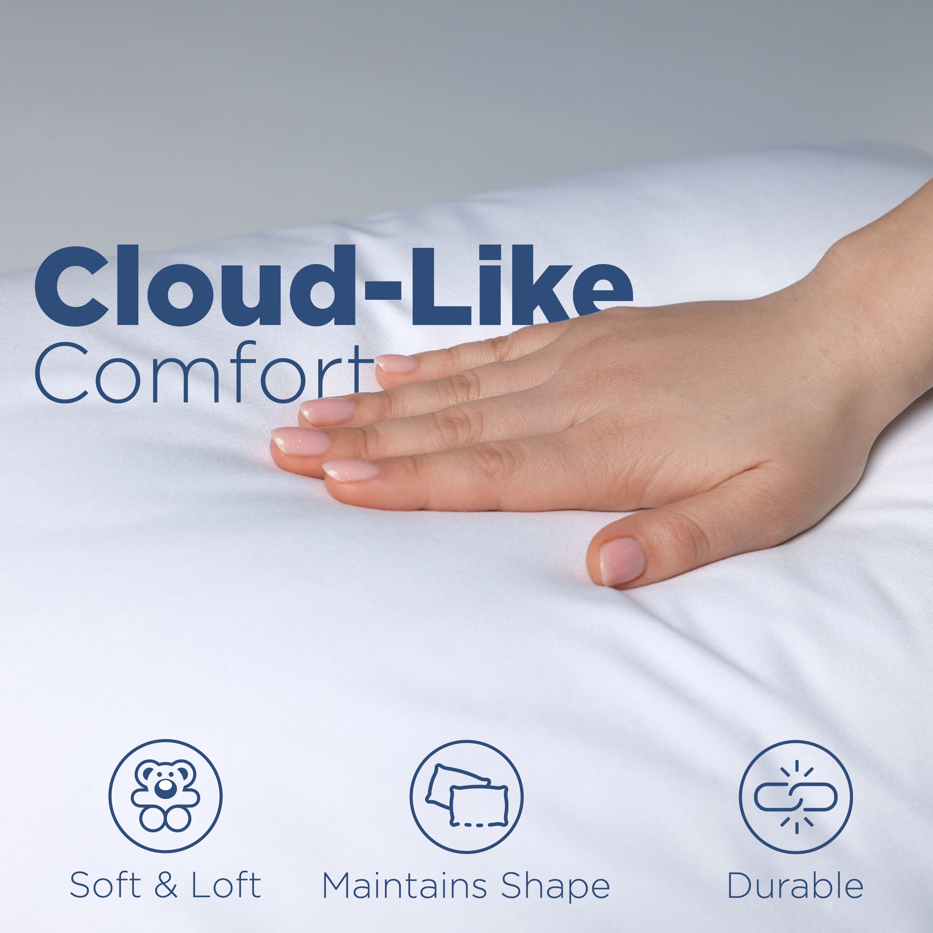 A hand rests on a soft, white pillow, highlighting its comfort and shape retention features.