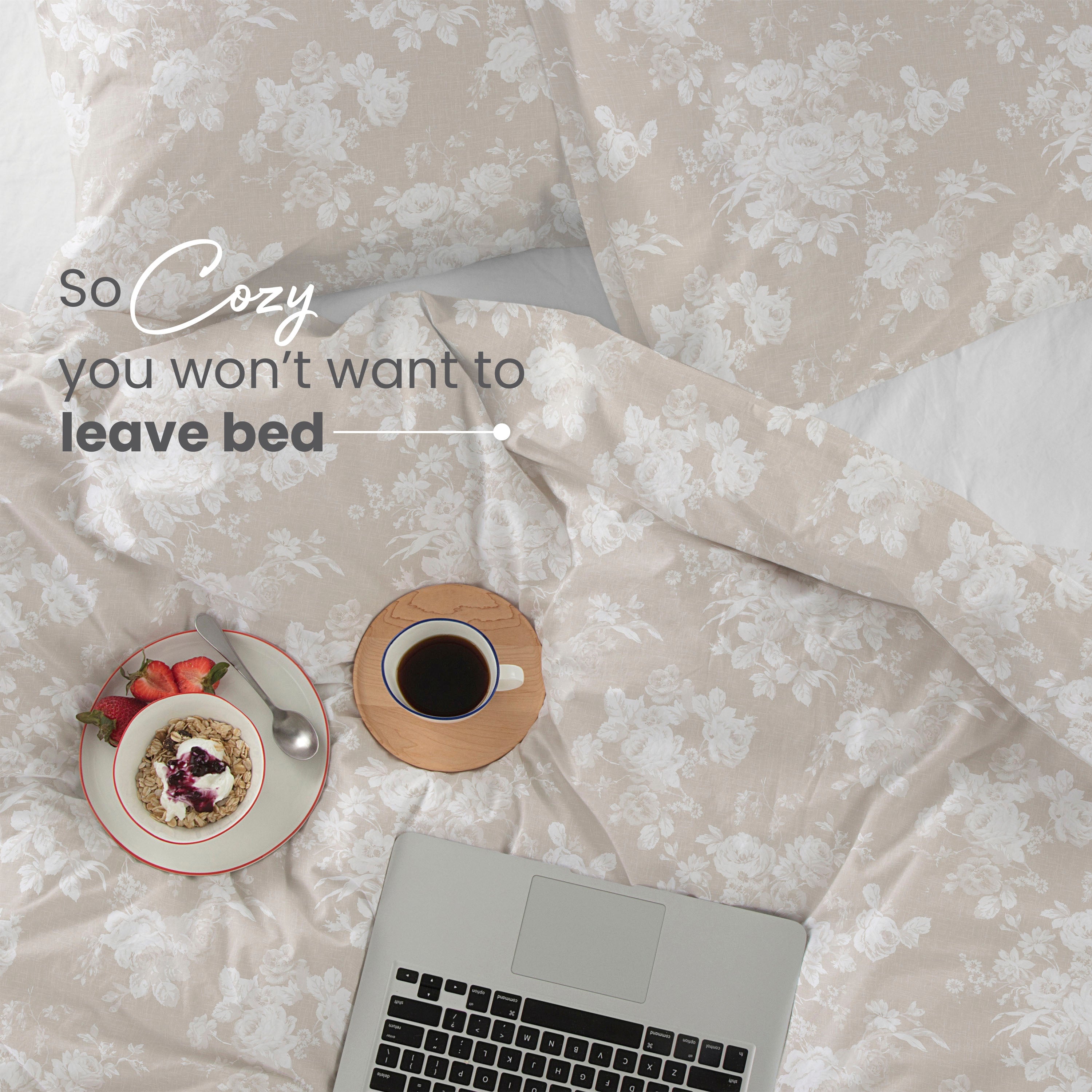Twin comforter set with floral pattern, a bowl of granola with fruit, a cup of coffee, and a laptop on a bed.