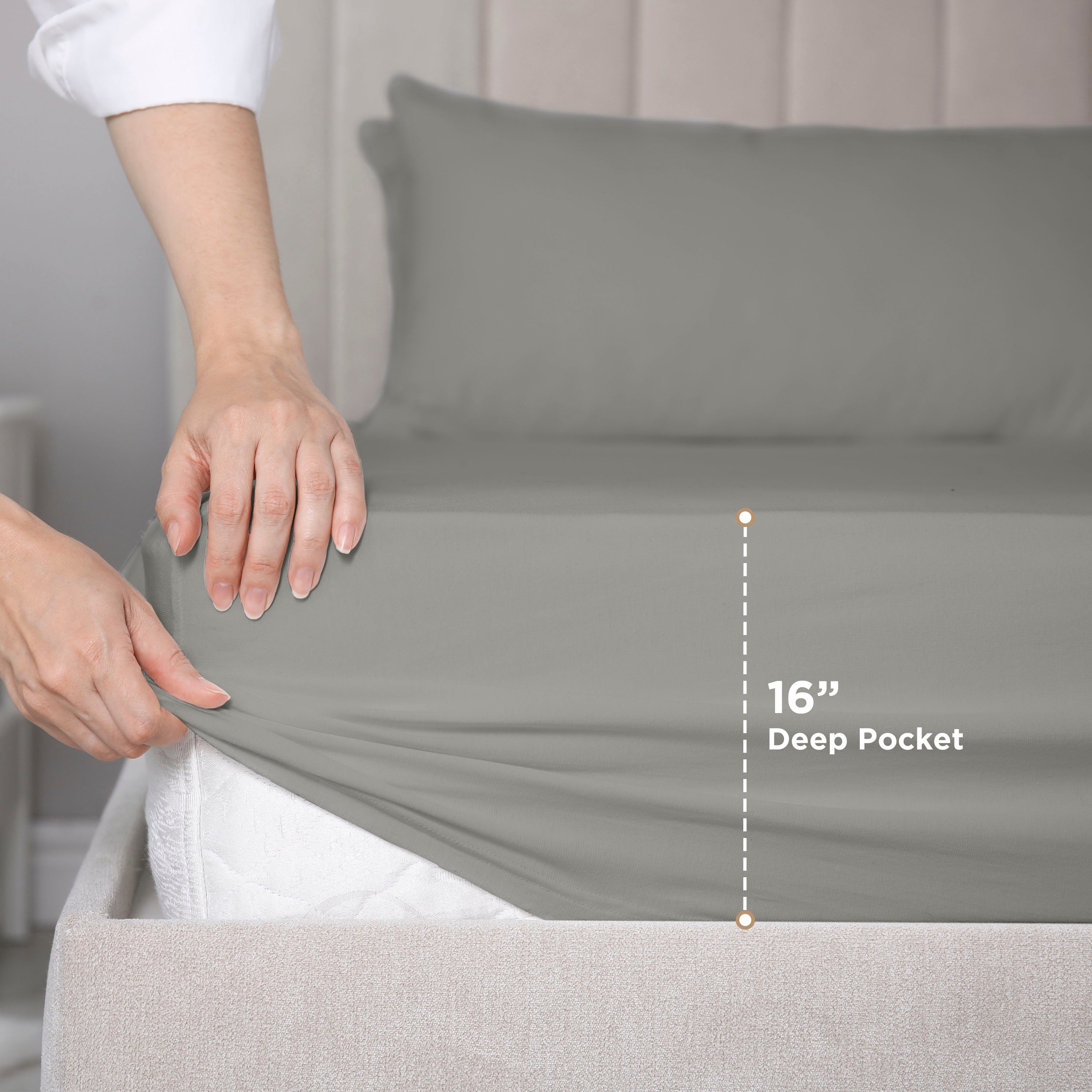 Hand adjusting a gray fitted sheet on a mattress, showing a 16-inch deep pocket feature.