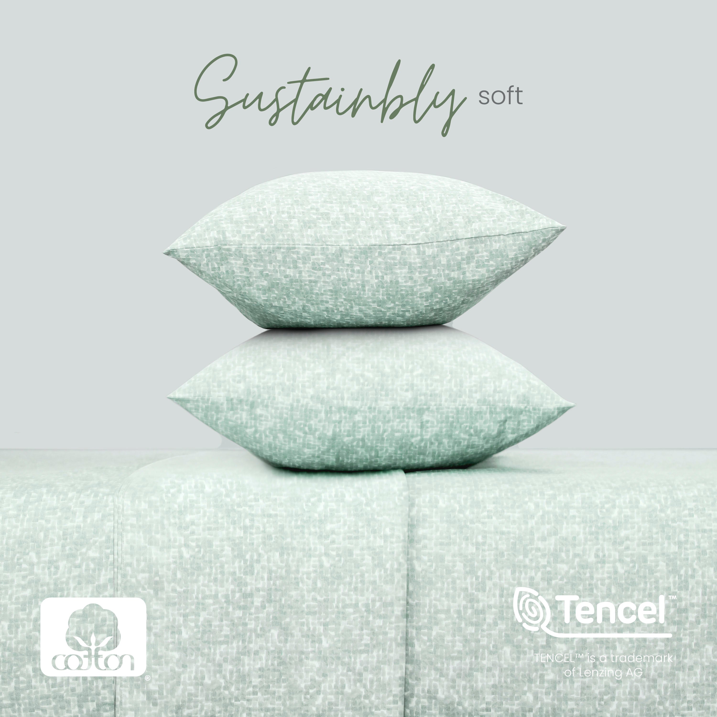 Two sage textured pillows stacked on a matching fabric background with 'Sustainably soft' text and Tencel logo.