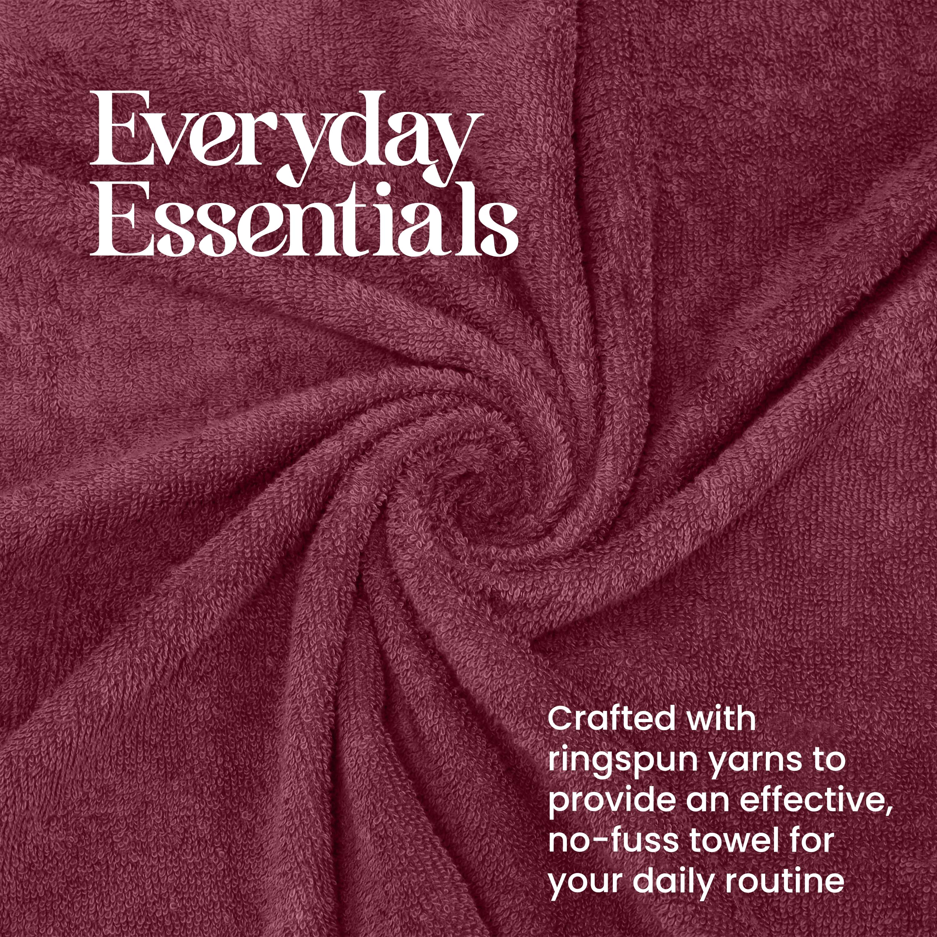 Burgundy towel set with a soft, textured surface, arranged in a spiral pattern.