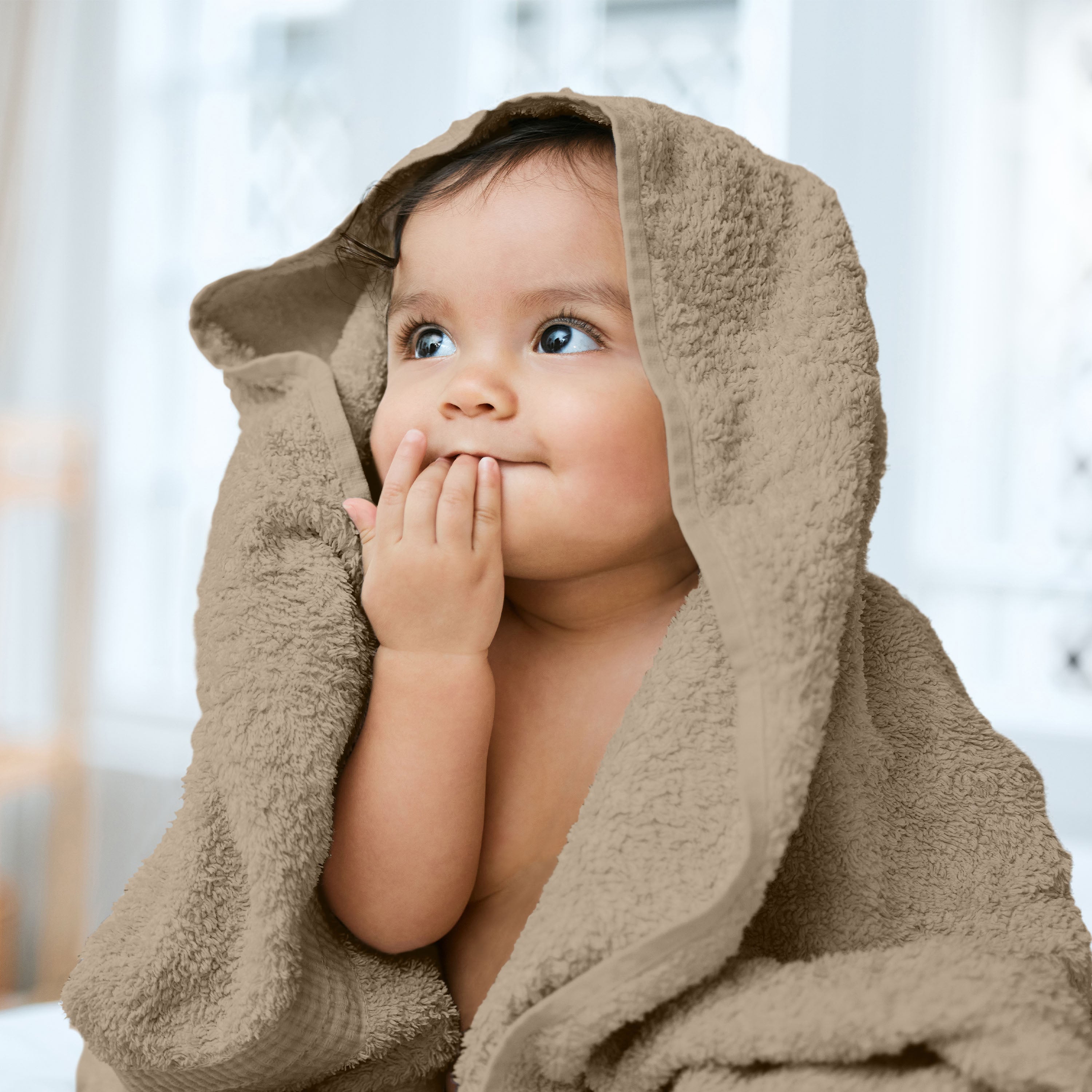 Baby wrapped in a beige bath towel