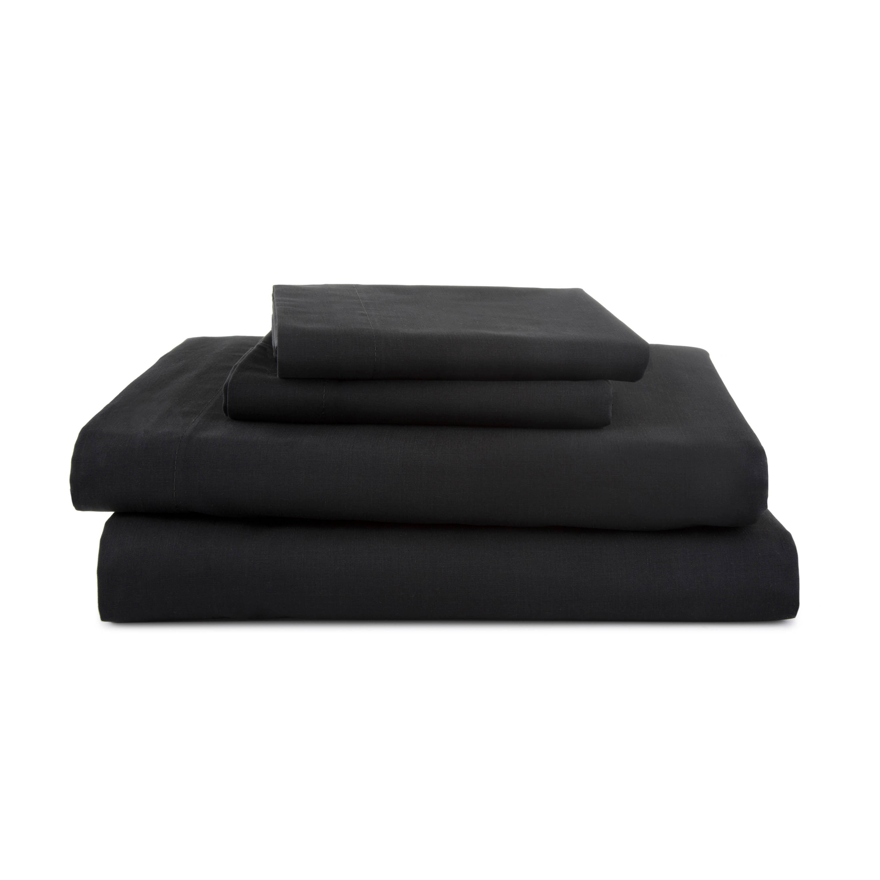 Four-piece black sheet set stacked neatly, featuring a fitted sheet, flat sheet, and two pillowcases.