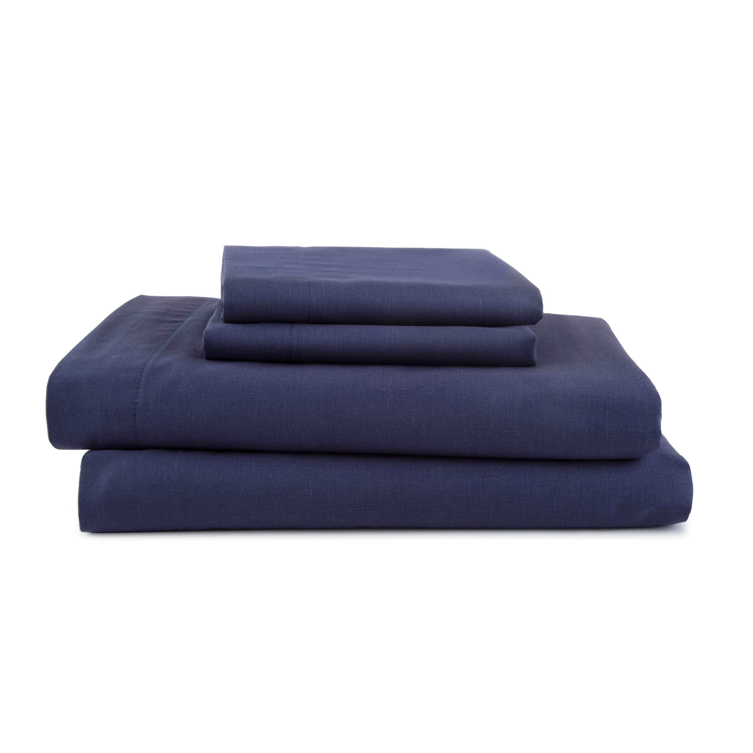 Navy blue sheet set stacked, including fitted sheet, flat sheet, and pillowcases.