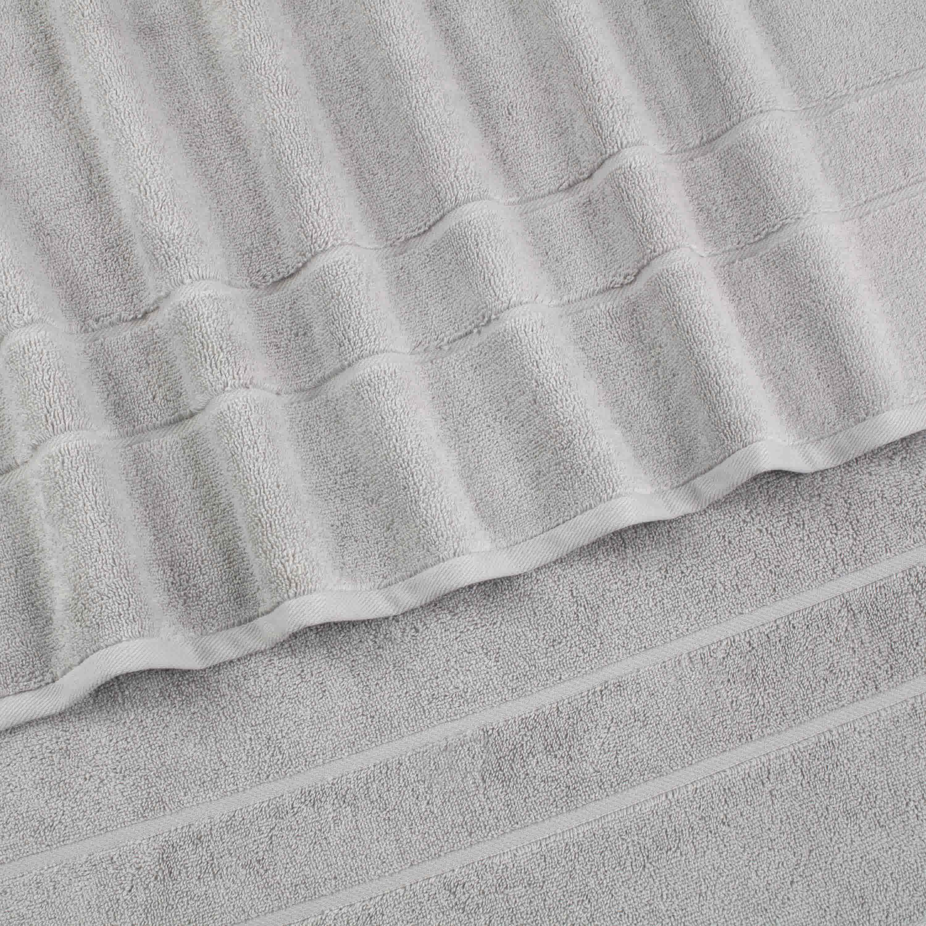 Two gray bath towels stacked, featuring a textured design with subtle stripes.