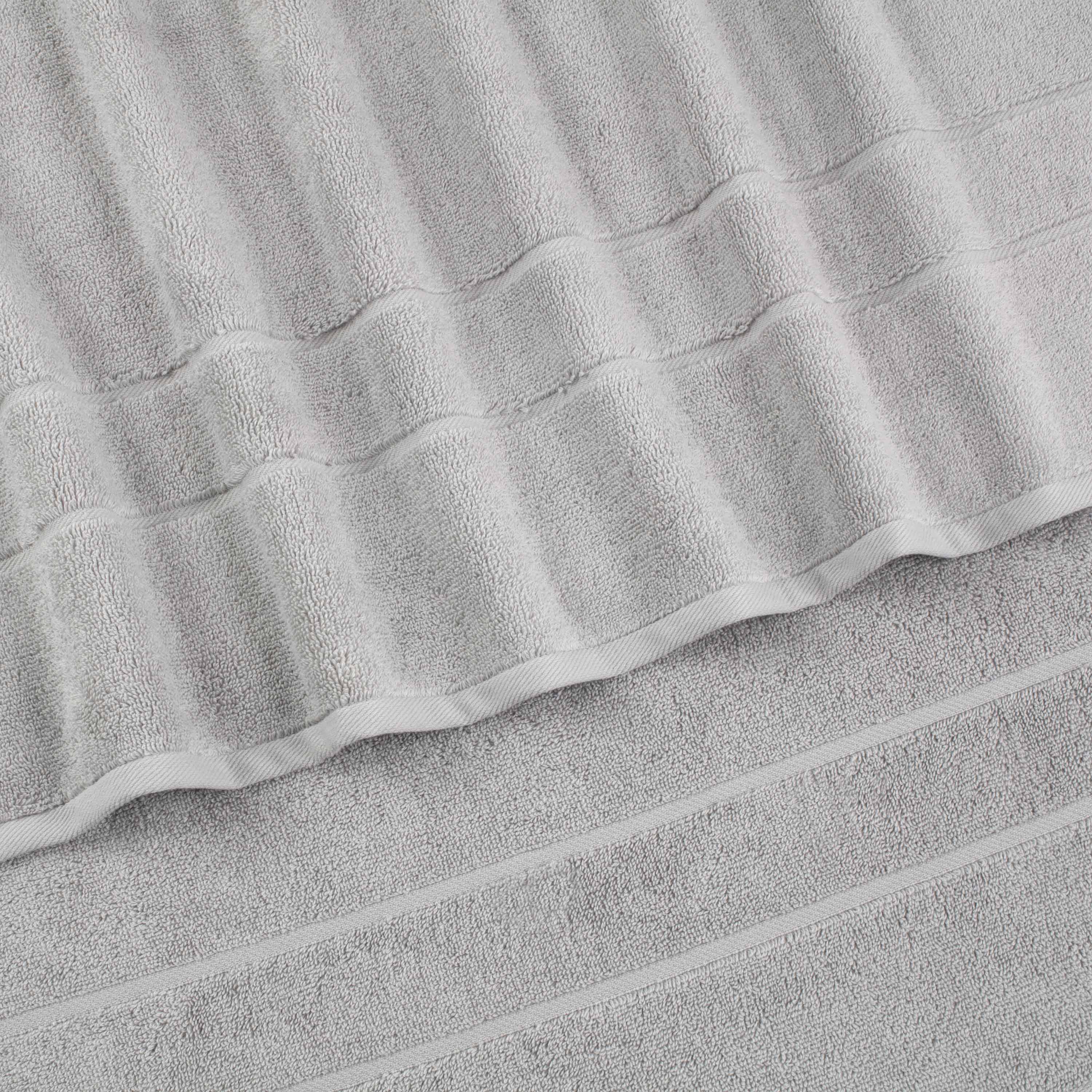 Gray wash cloths with textured stripes, stacked neatly on a flat surface.