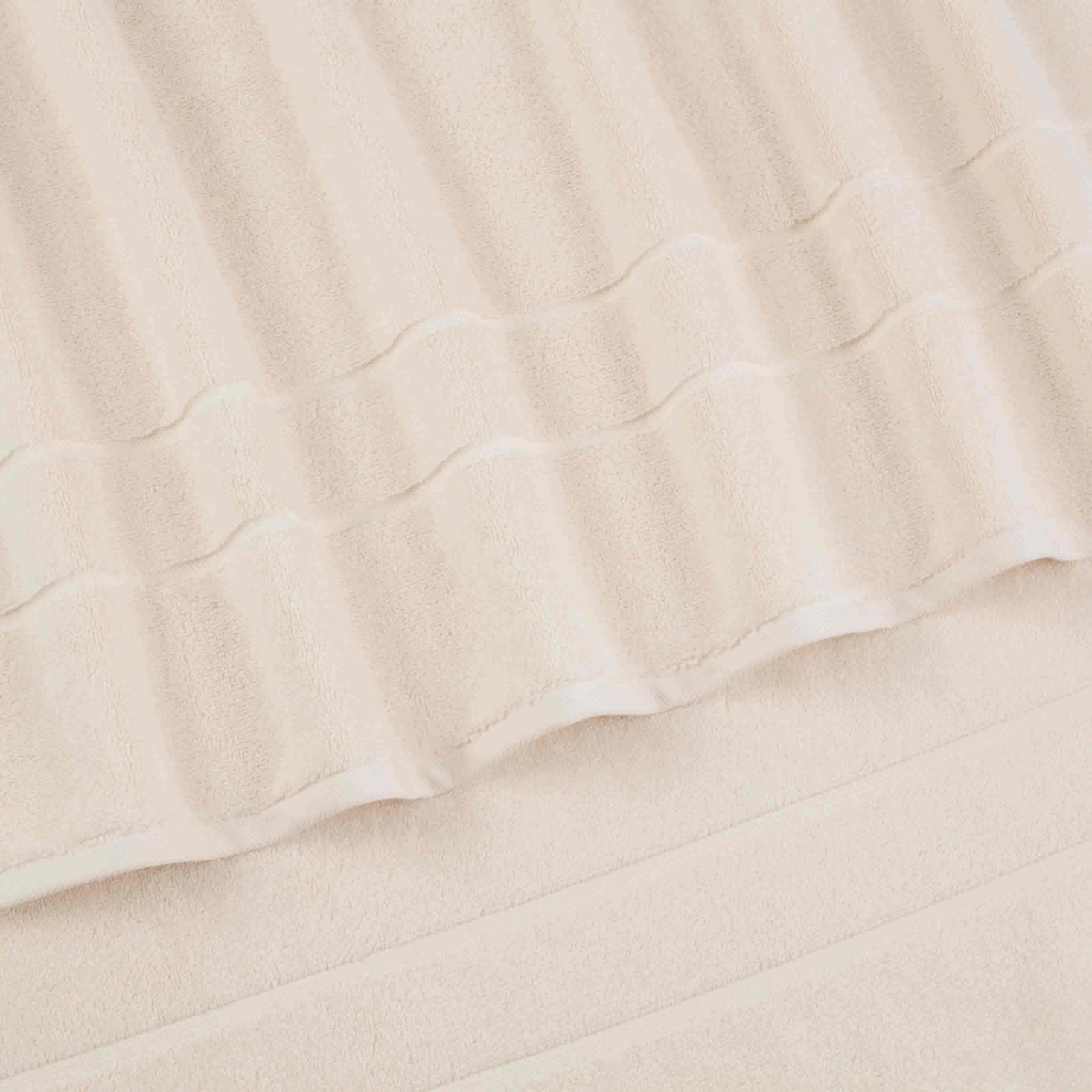 Two beige hand towels with a textured stripe design, stacked on top of each other.