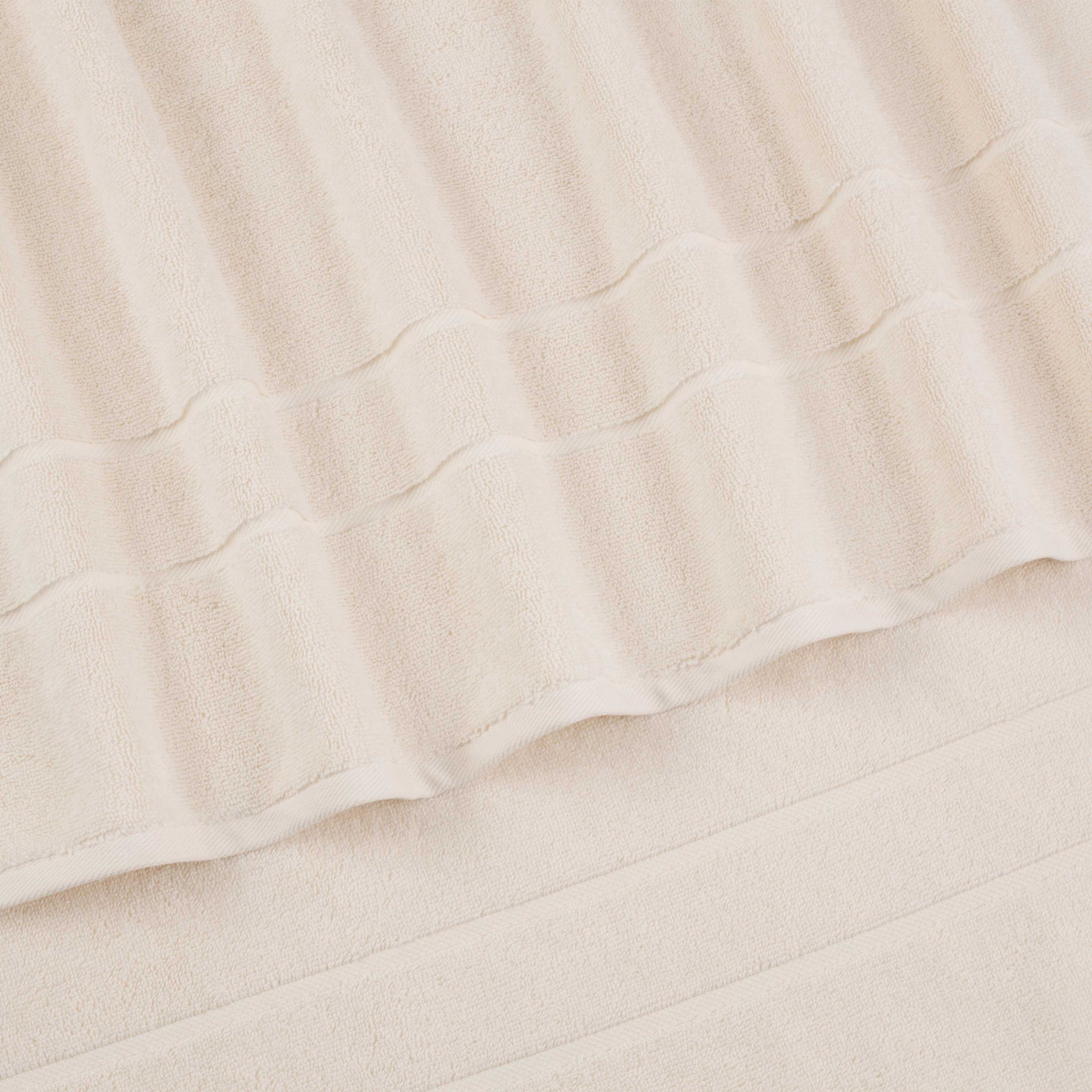 Set of four wash cloths in a soft, textured fabric with a light beige color.