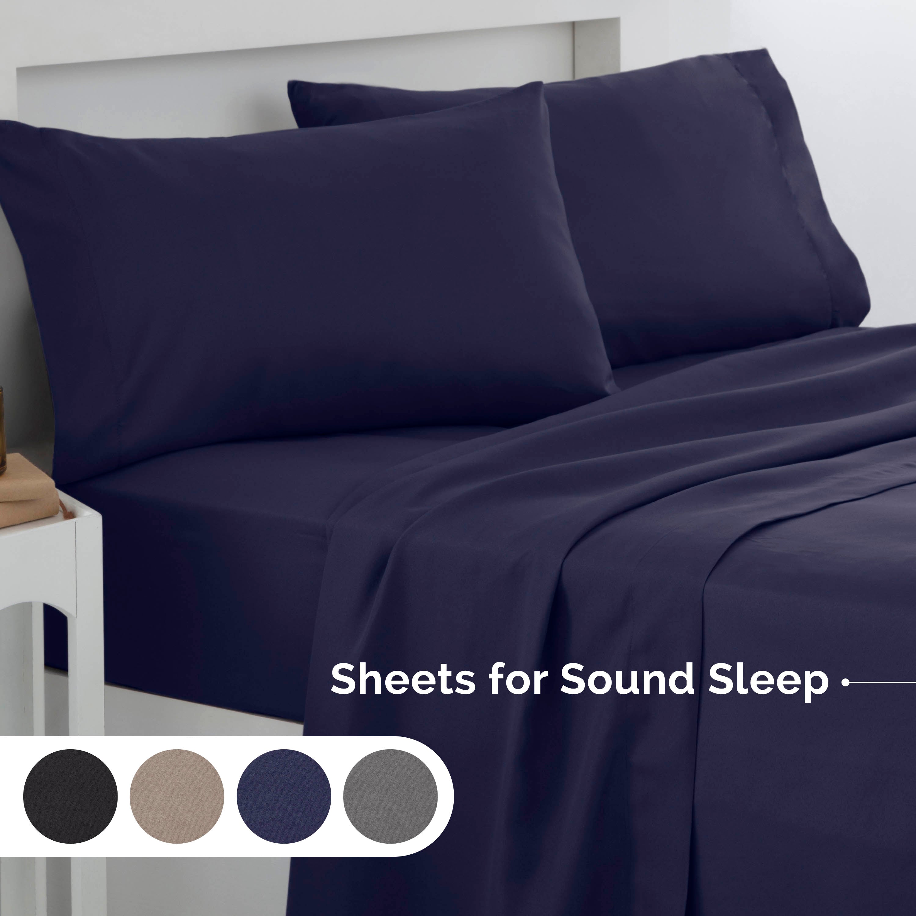 Navy brushed microfiber sheet set with two matching pillows on a bed, displayed with color options below.
