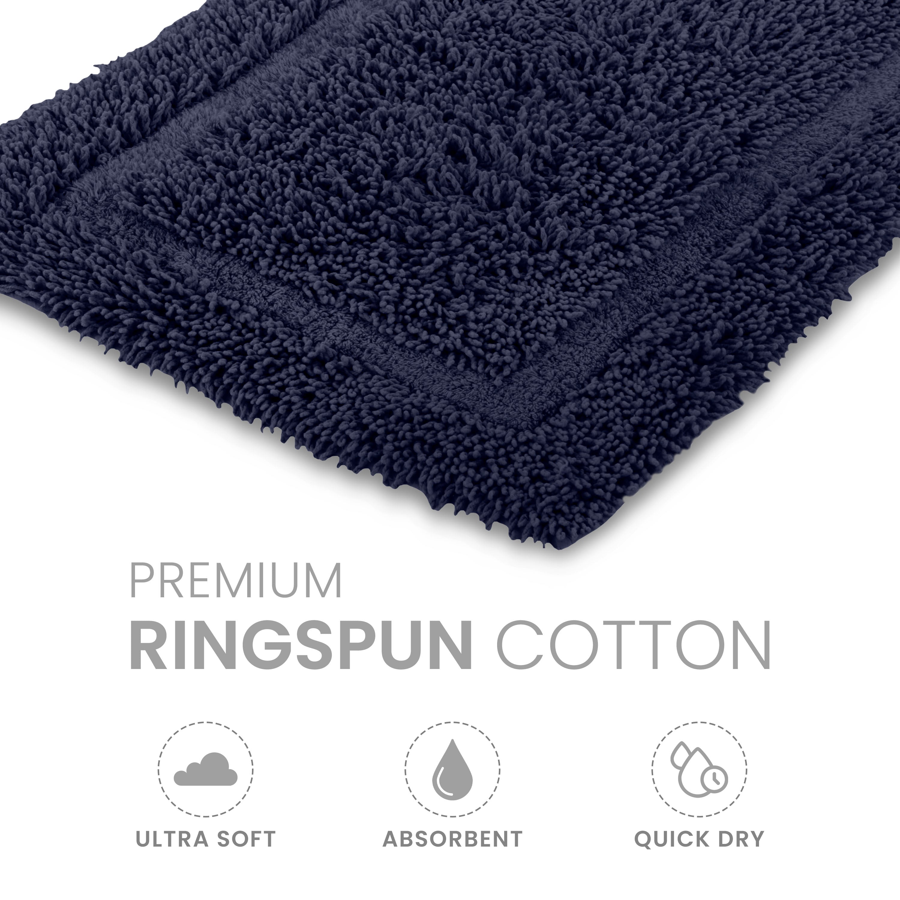 Navy blue bath rug made of ringspun cotton with a textured surface and bordered design.