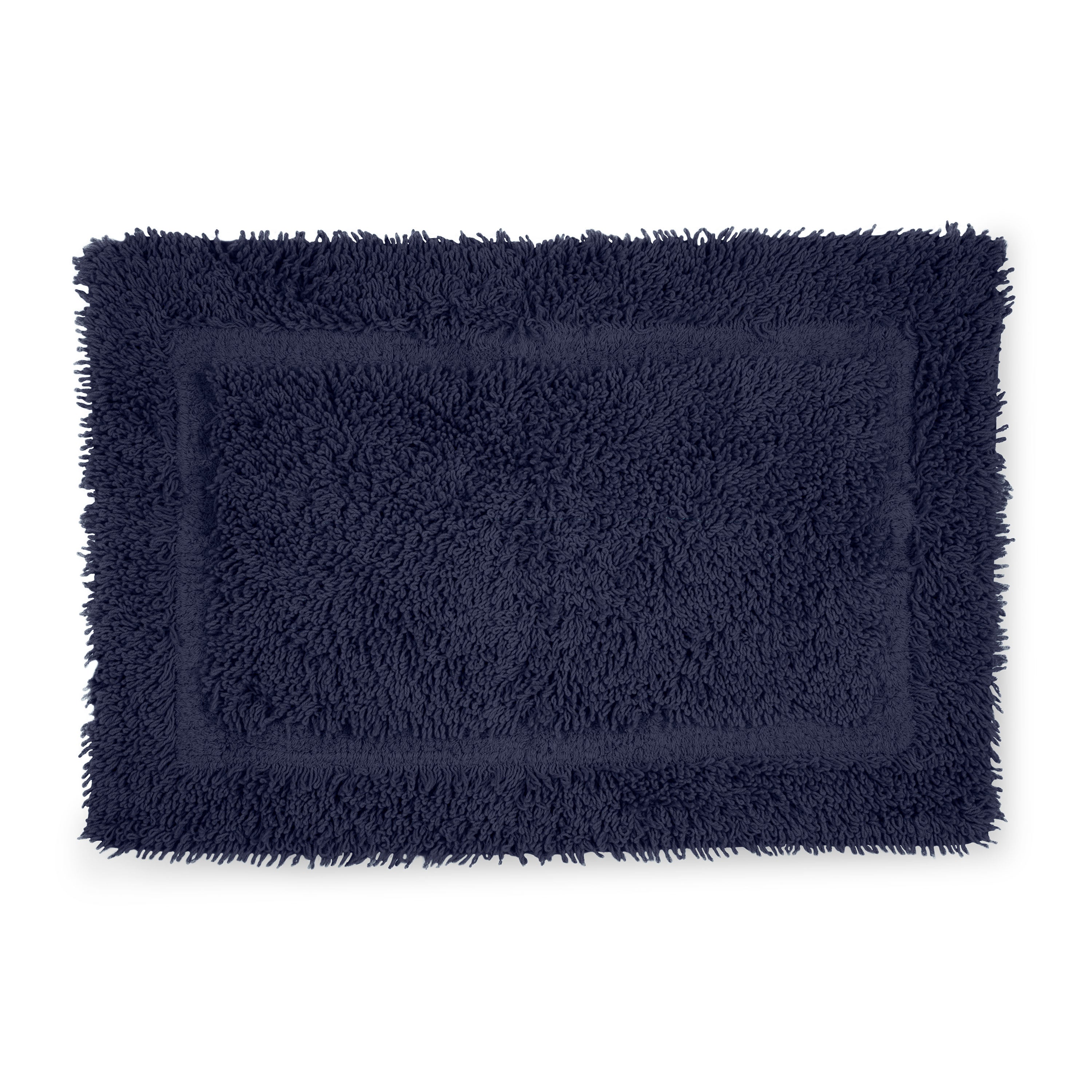 Navy blue bath rug with a plush, textured surface and a rectangular shape.