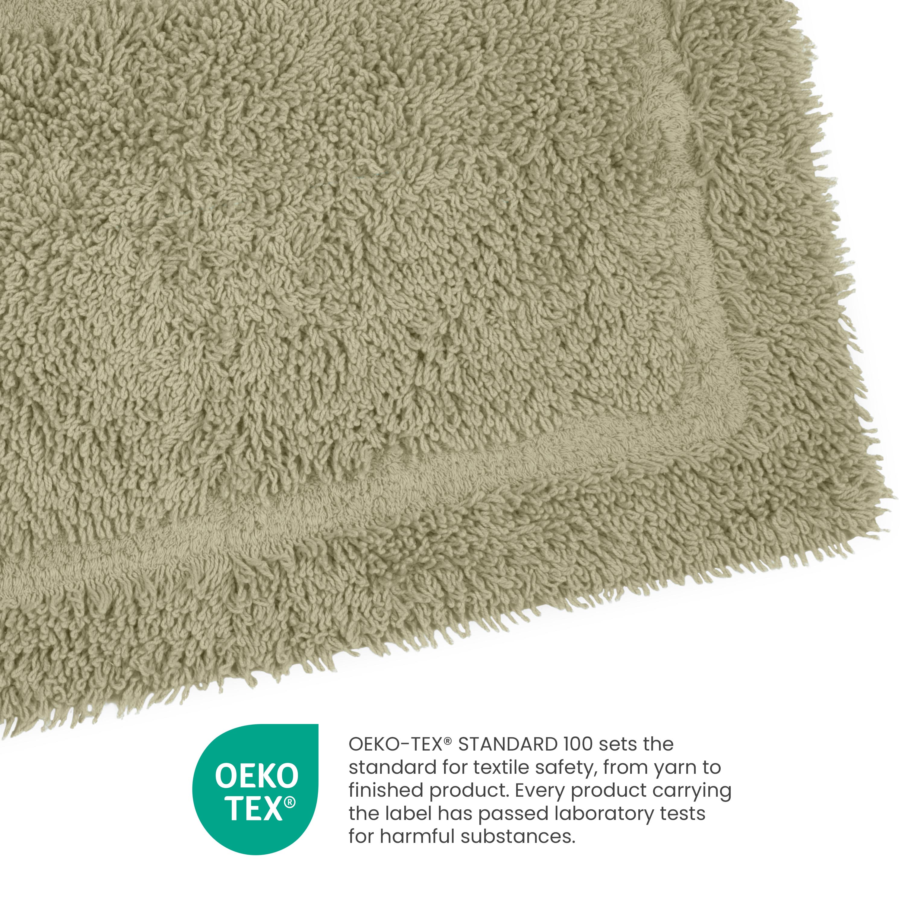 Light green ringspun cotton bath rug with a textured surface and a bordered edge.