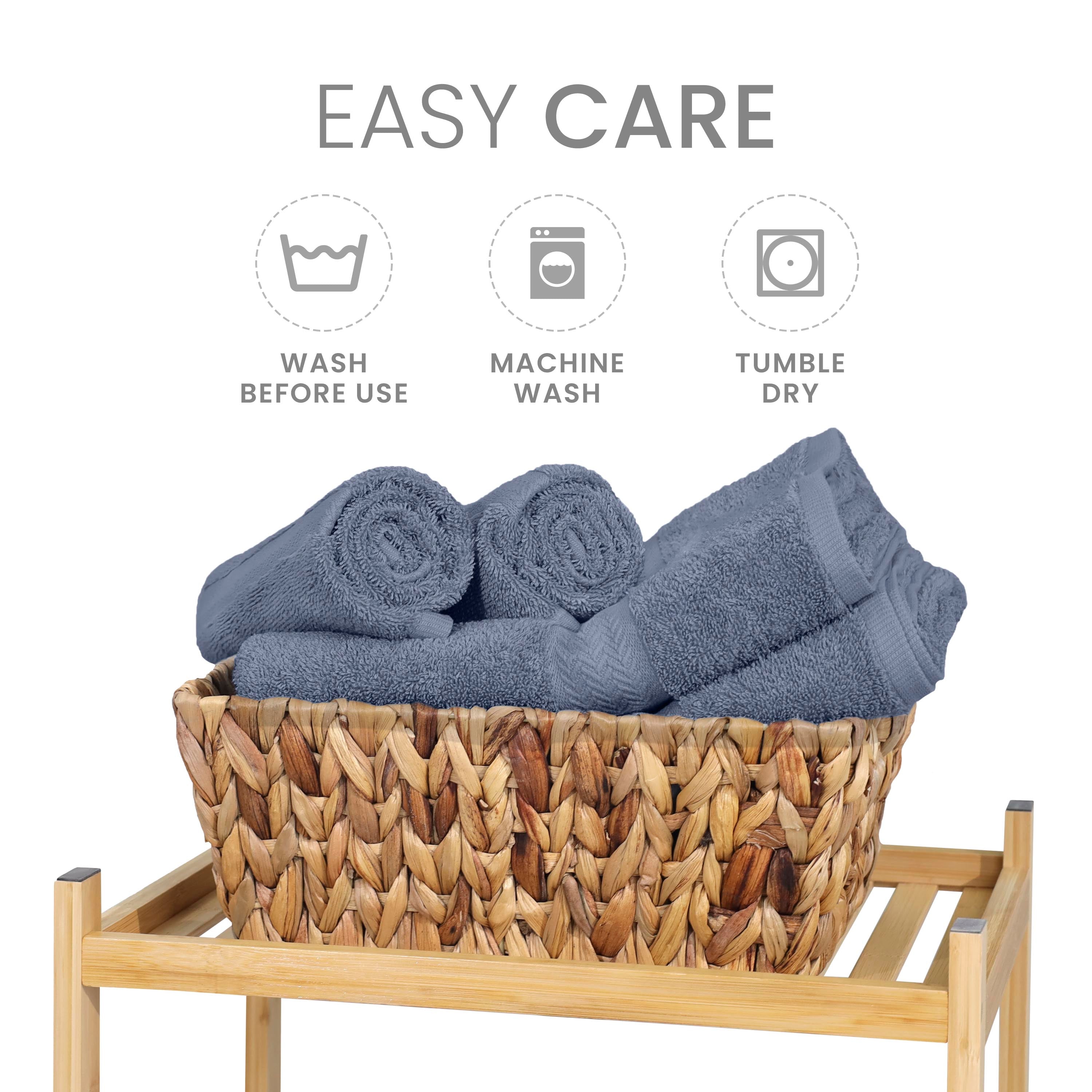 Gray towels are neatly arranged in a woven basket on a wooden stand, with care instructions displayed above.