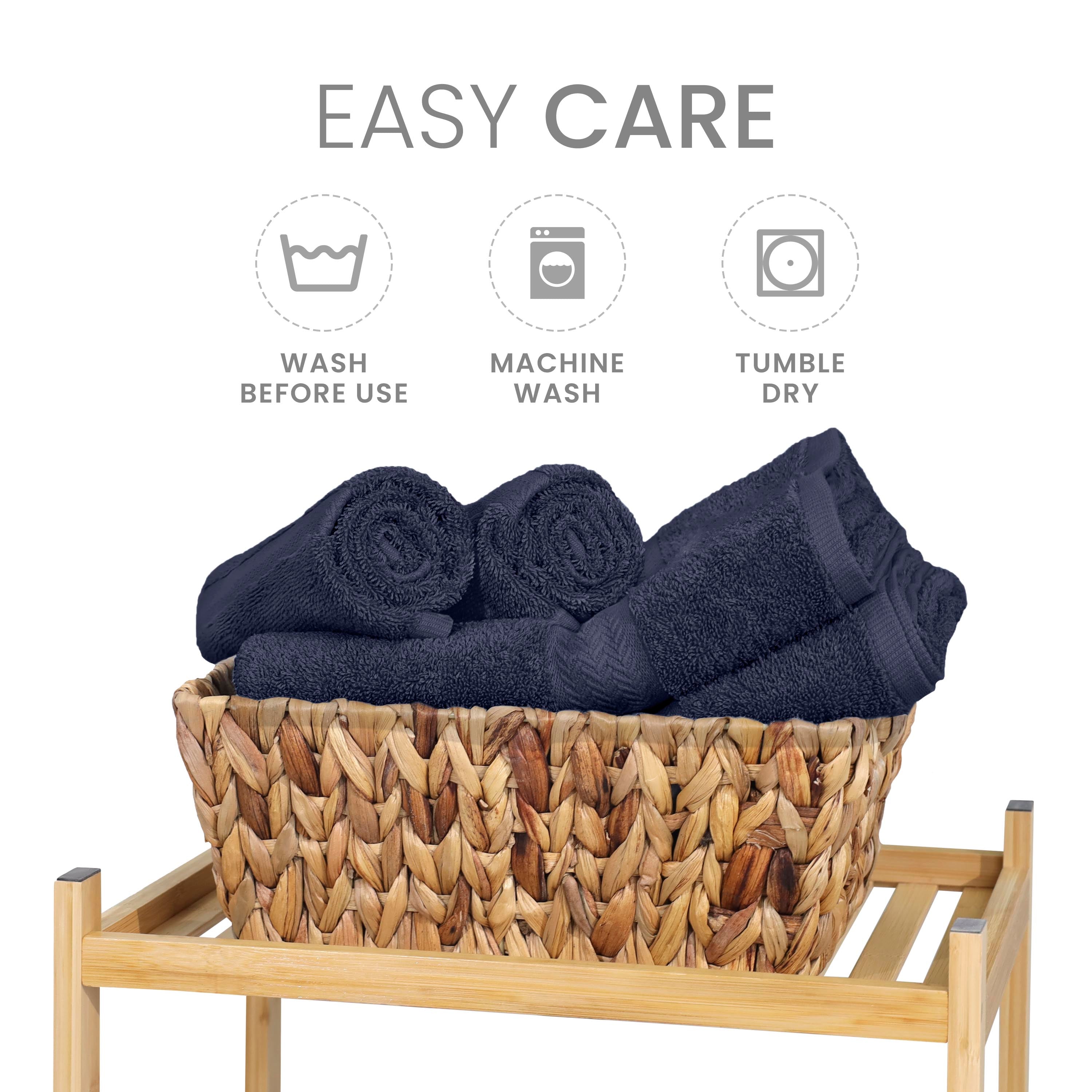 A woven basket holds neatly rolled dark towels, with care instructions displayed above.