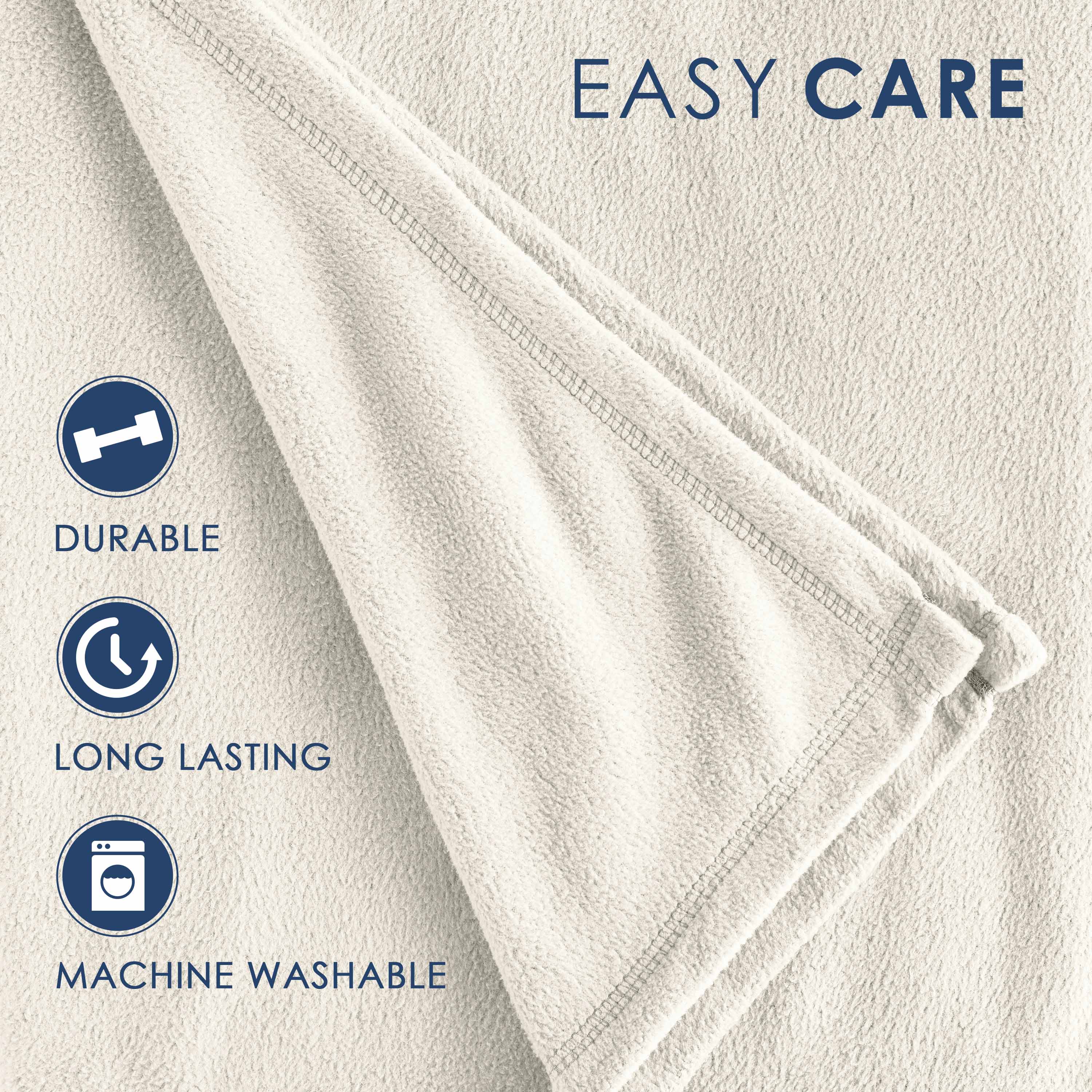 Light beige fleece blanket with a soft texture and stitched edges, featuring care instructions.