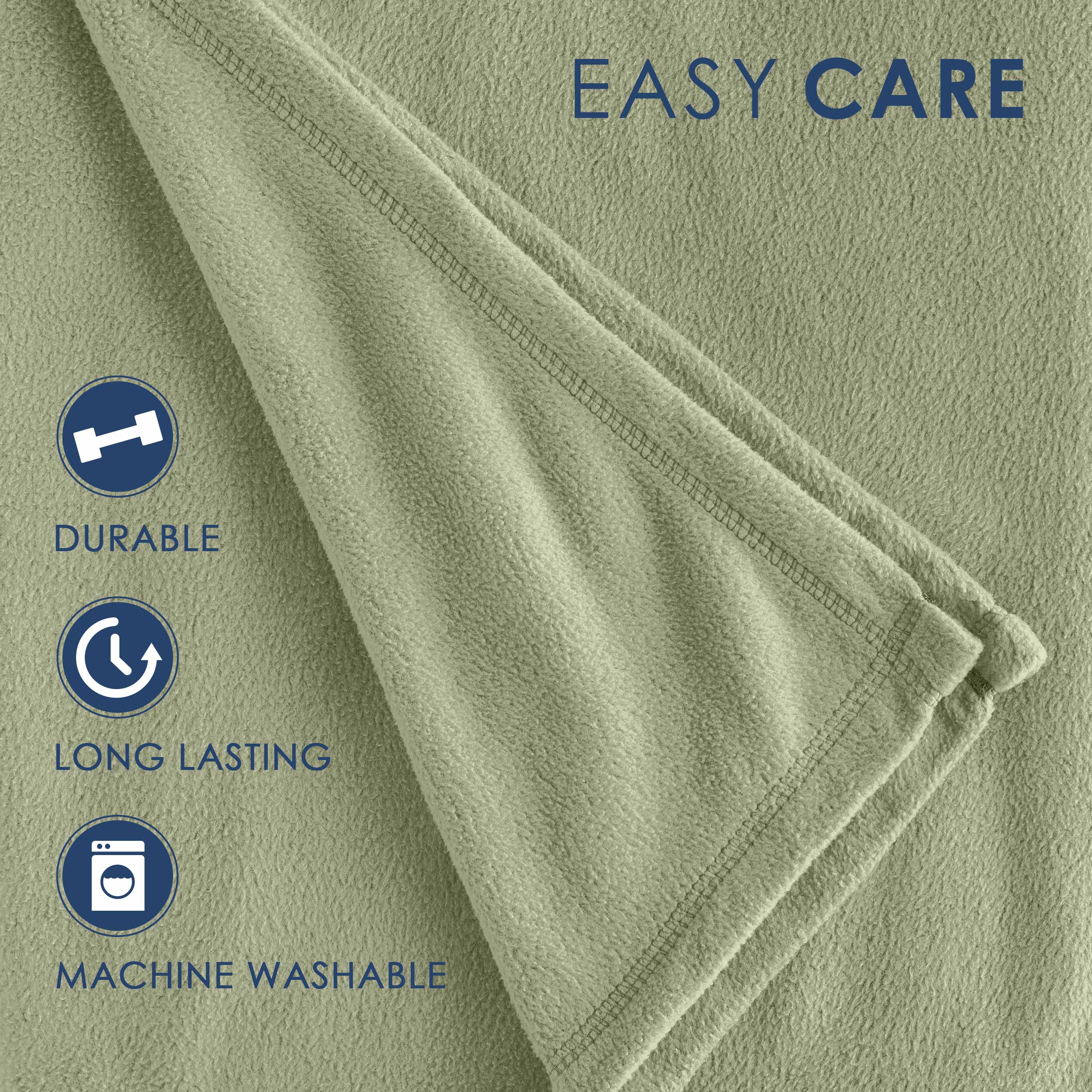 Light green fleece blanket with a soft texture and stitched edges, labeled as durable and machine washable.