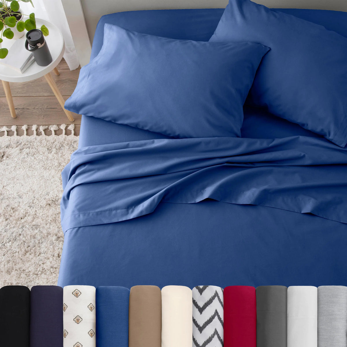 Neatly made bed with blue bedding in a bedroom setting.