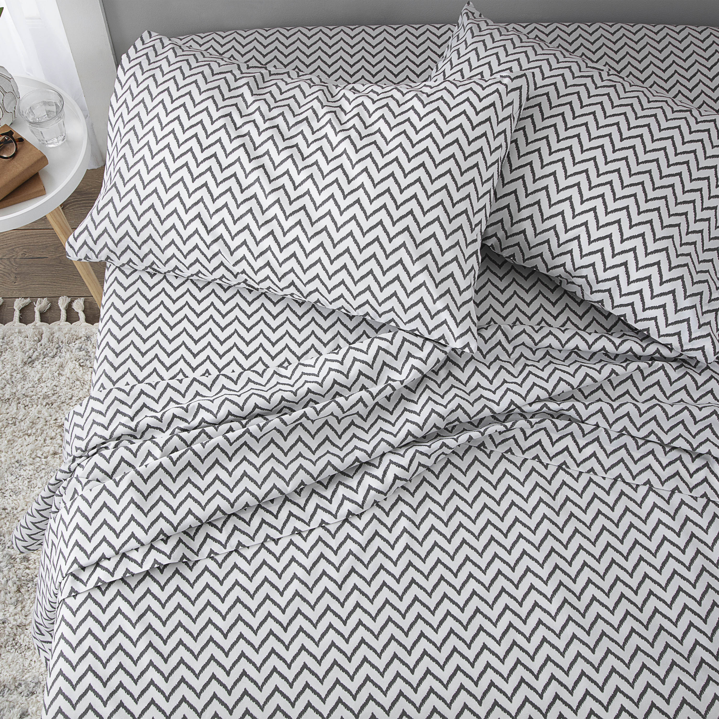 Gray and white chevron patterned sheet set with two matching pillowcases.