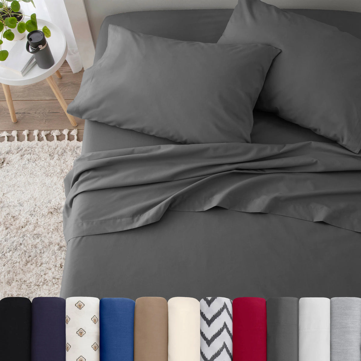 Neatly made bed with grey bedding in a bedroom setting.