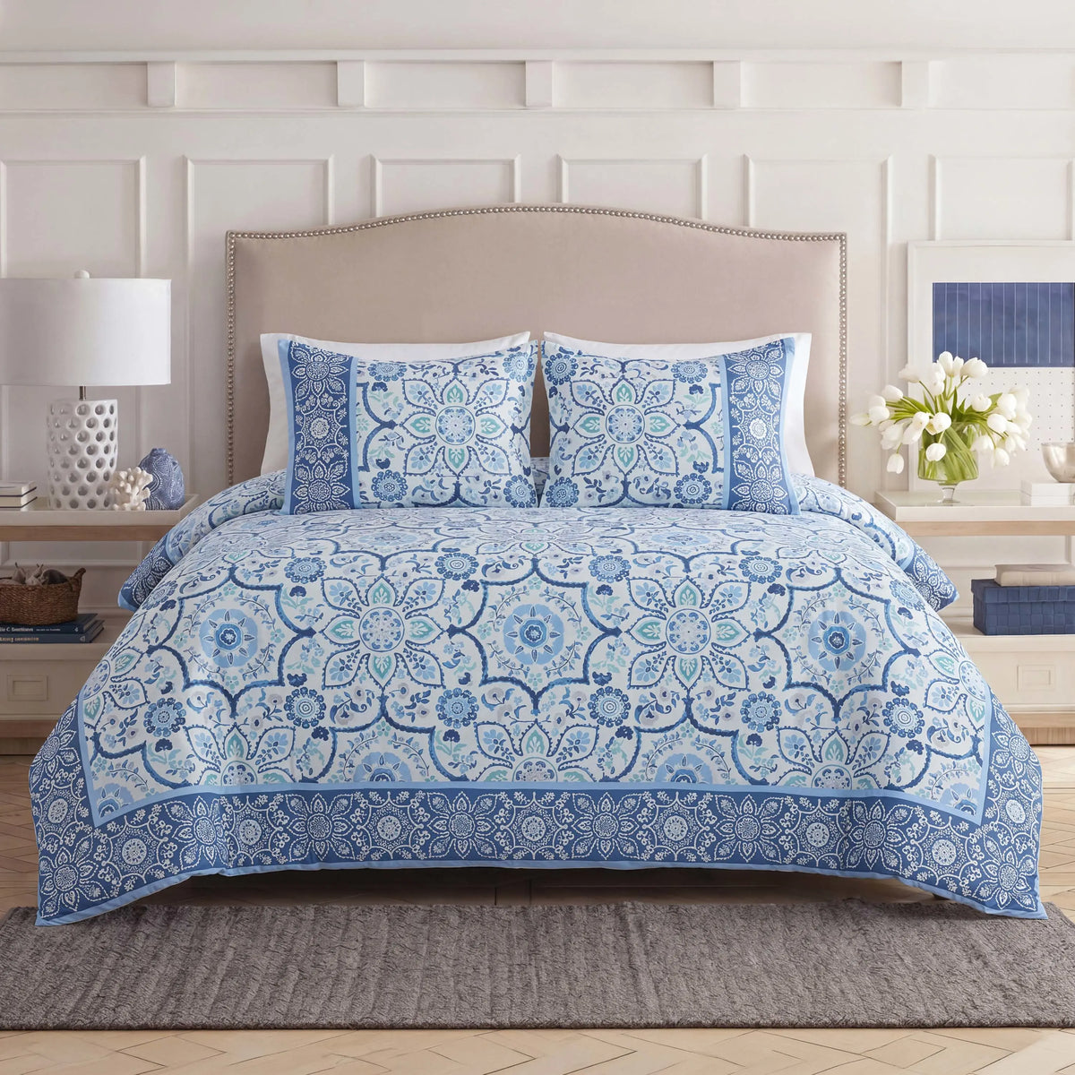 Front view of comforter with shams on the bed