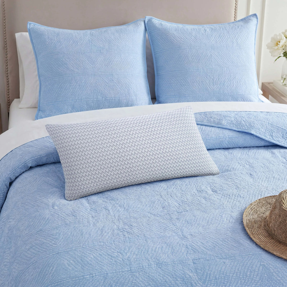 Decorative pillow on the Tideline coverlet with the shams.
