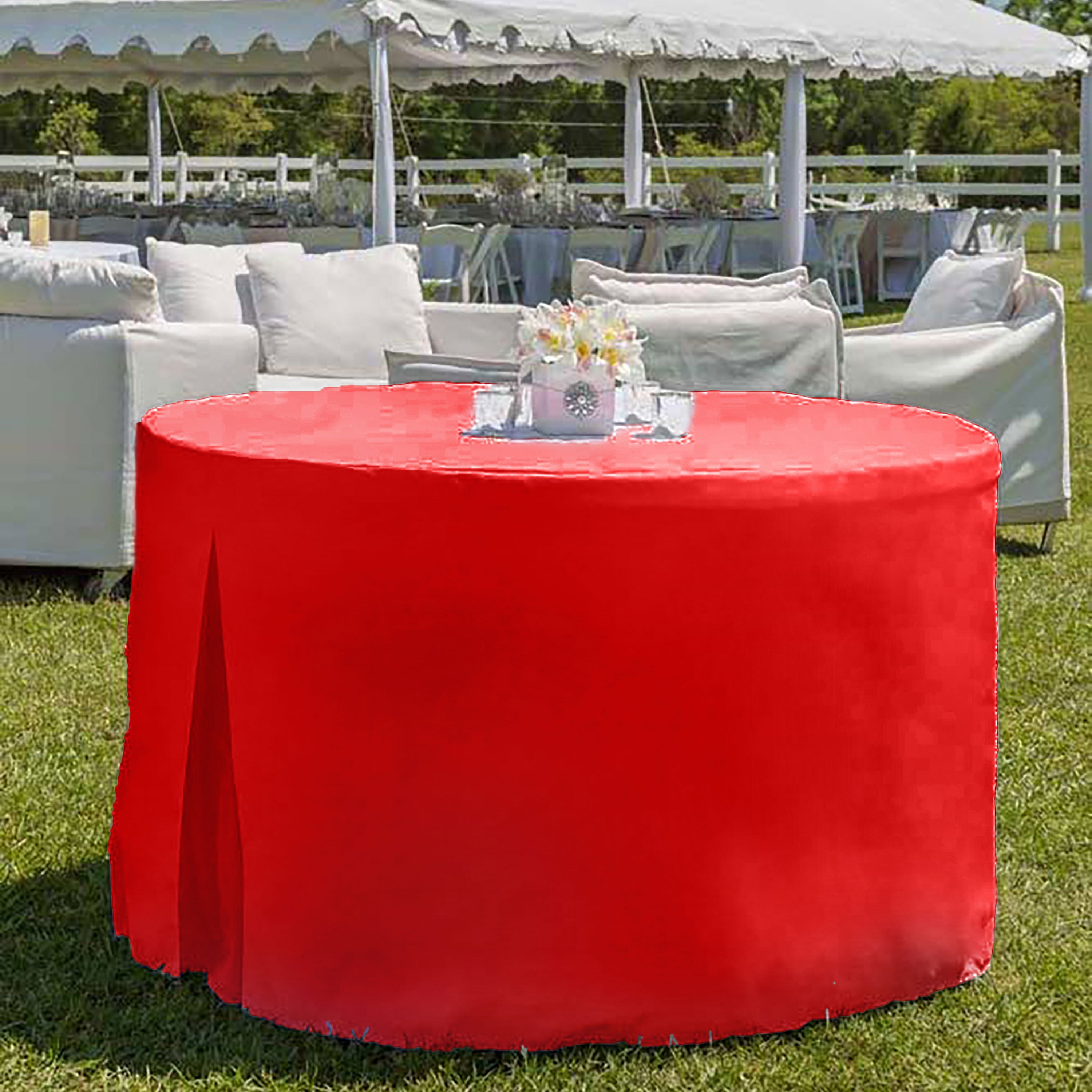 Red round table cover draped over a 60-inch table in an outdoor setting with white seating in the background.