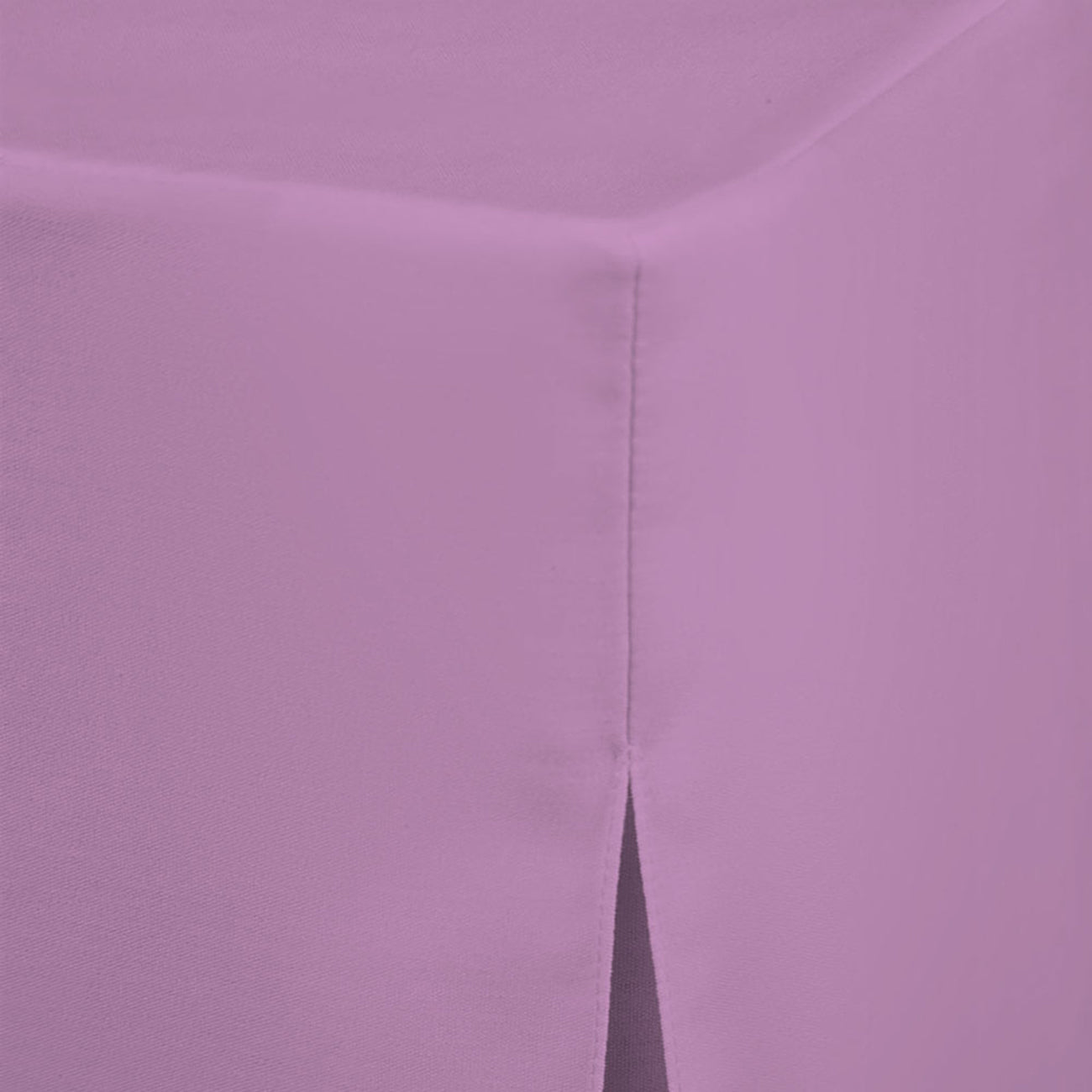 Round table cover in light purple fabric with a corner seam and a slit detail.