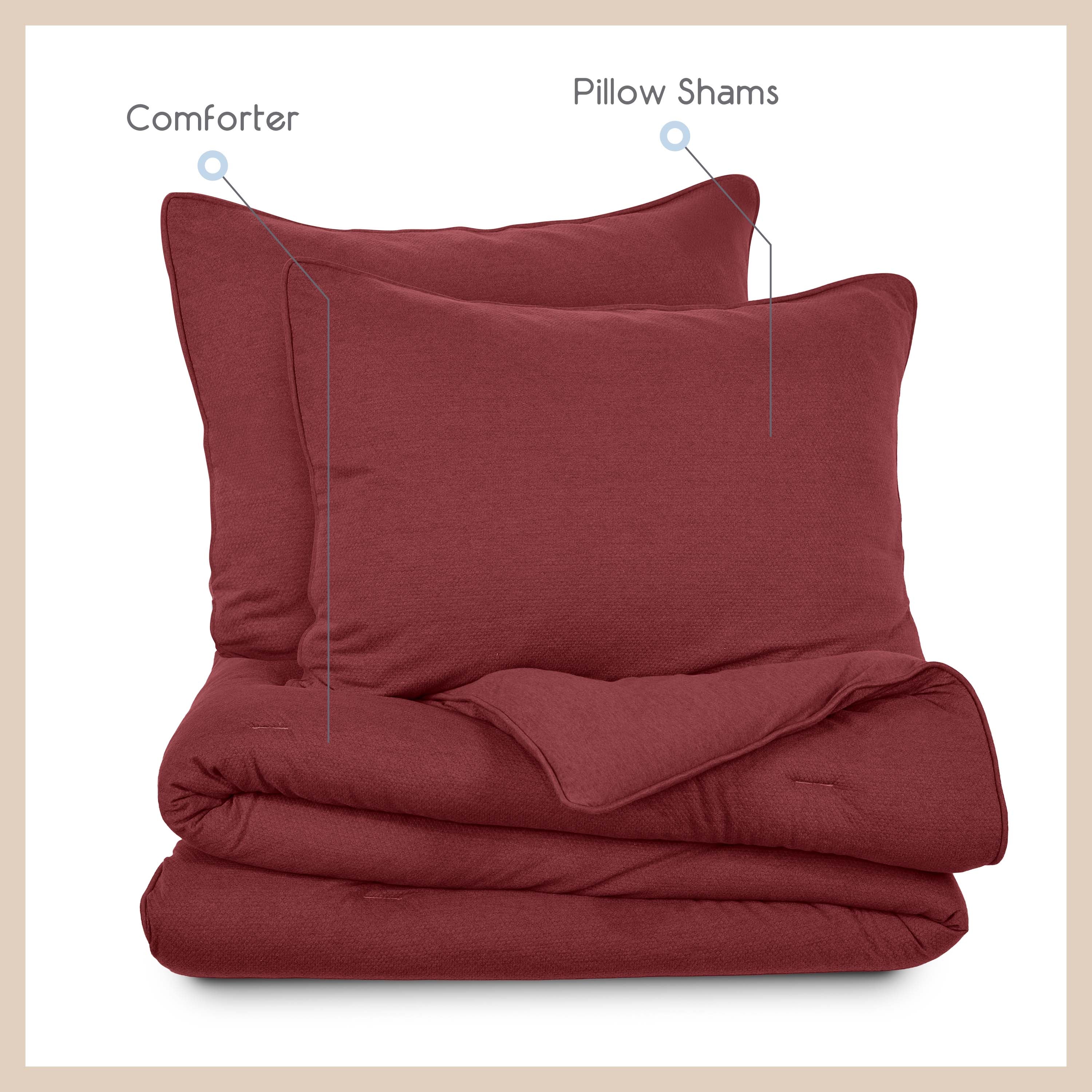 Red comforter set featuring a comforter and two pillow shams stacked together.