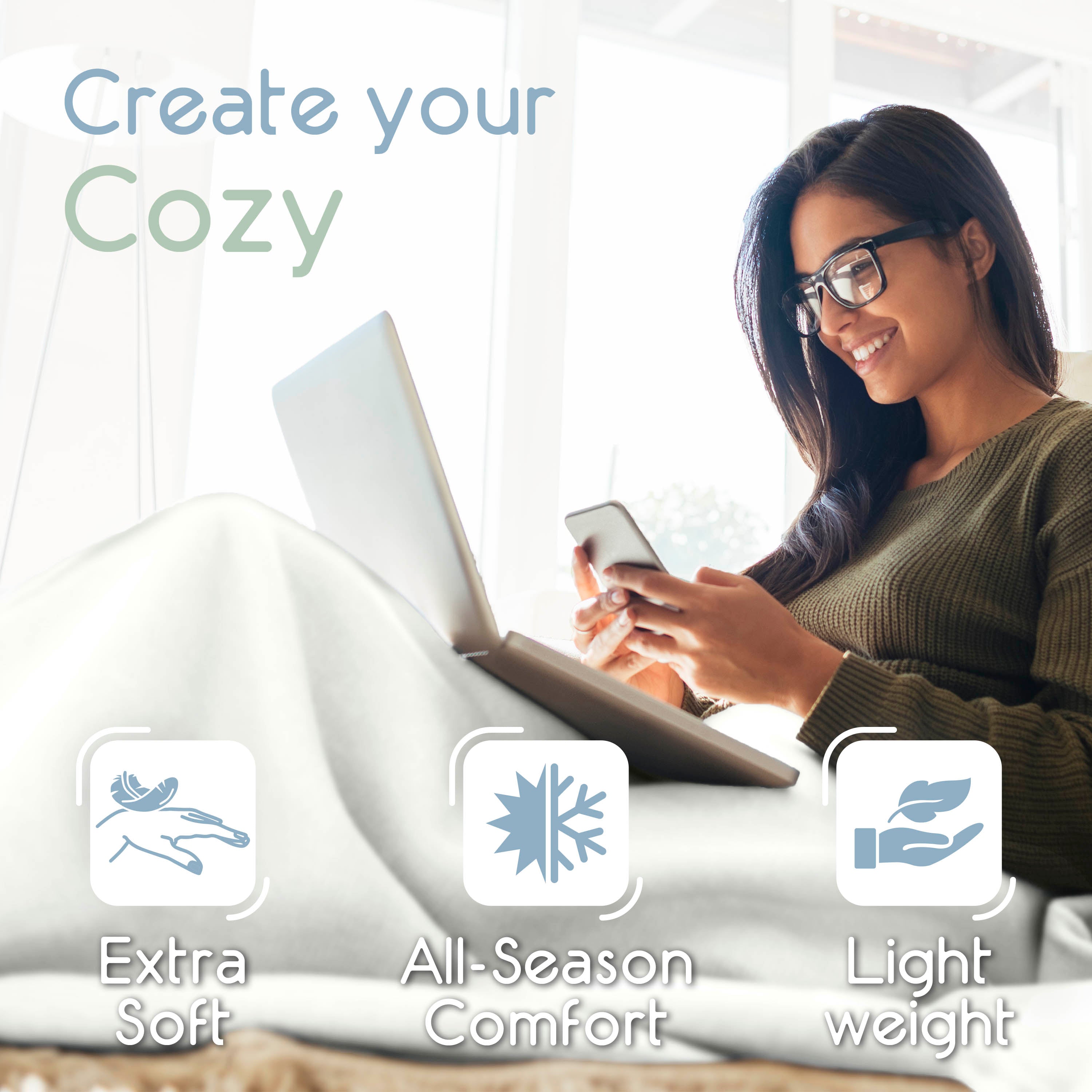 A woman sits comfortably with a laptop and smartphone, covered by a soft, light-colored blanket.
