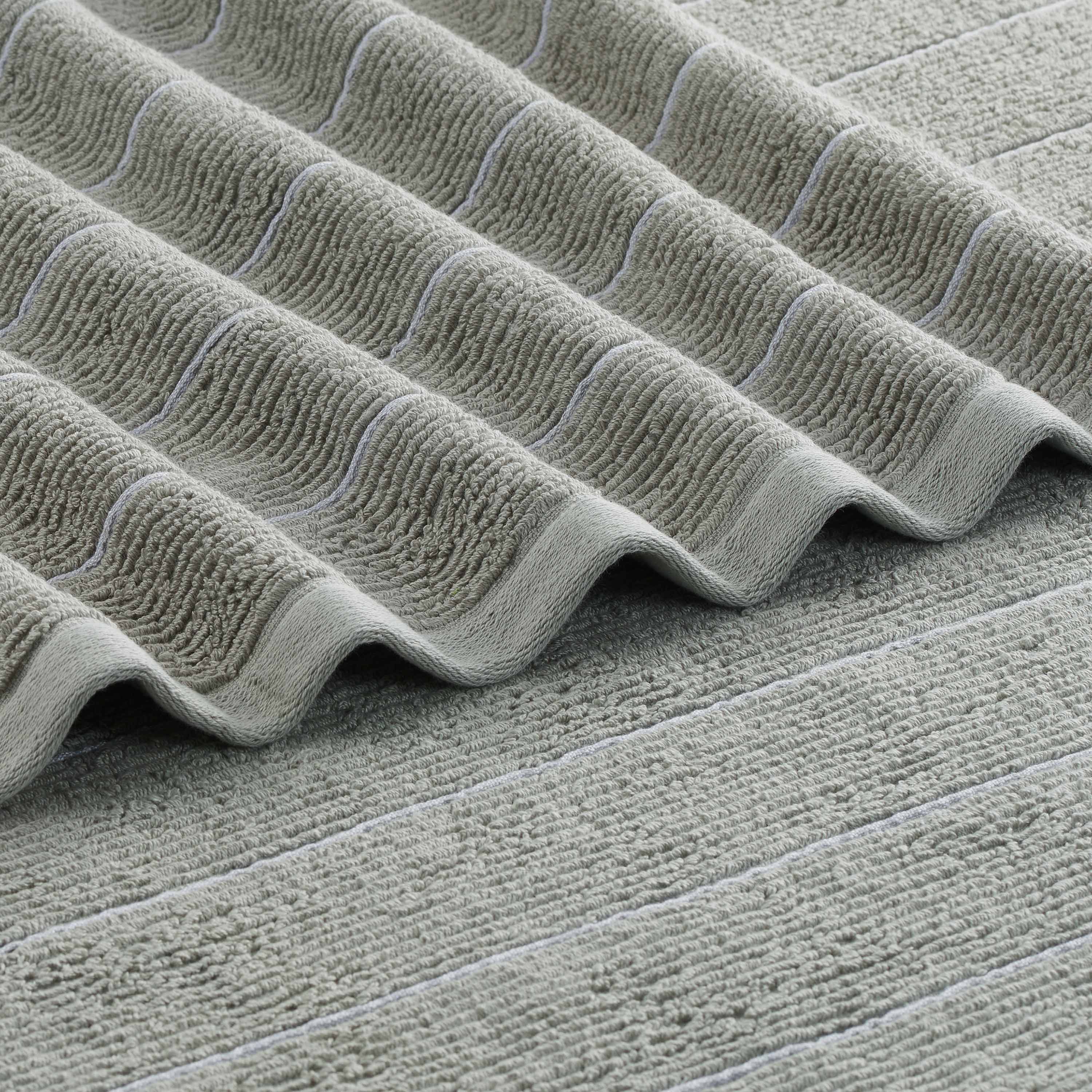 Textured green towel with slub stripe pattern and contrasting light stripes.
