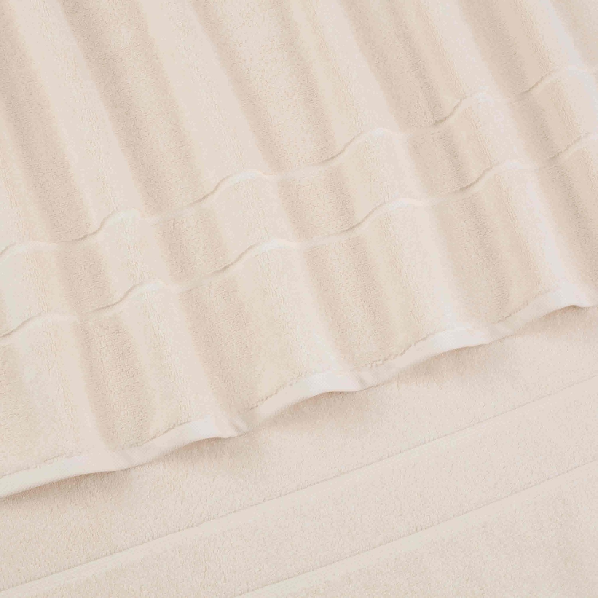 Close-up of ivory quilted fabric texture