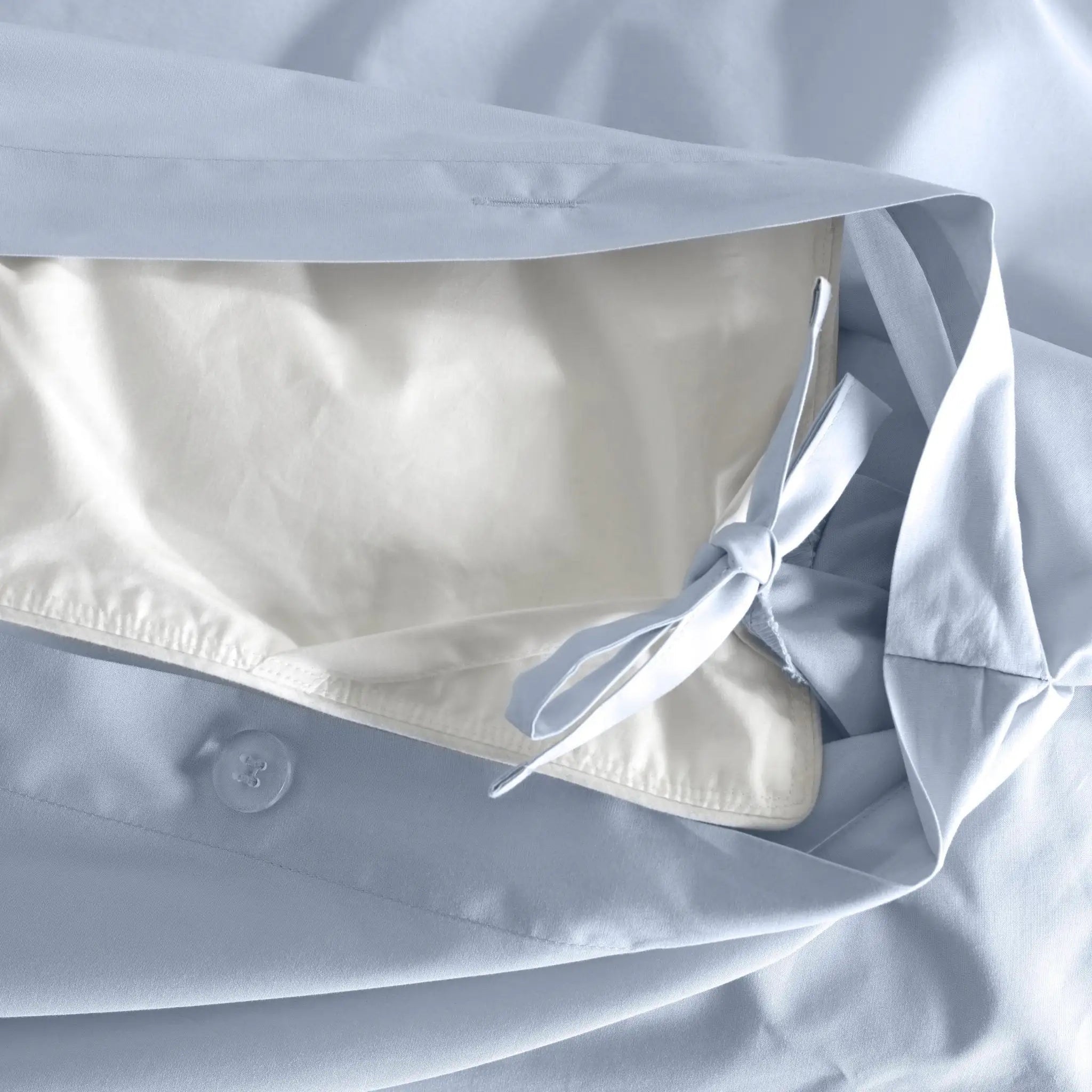 Close-up of a light blue button-front pillow sham.