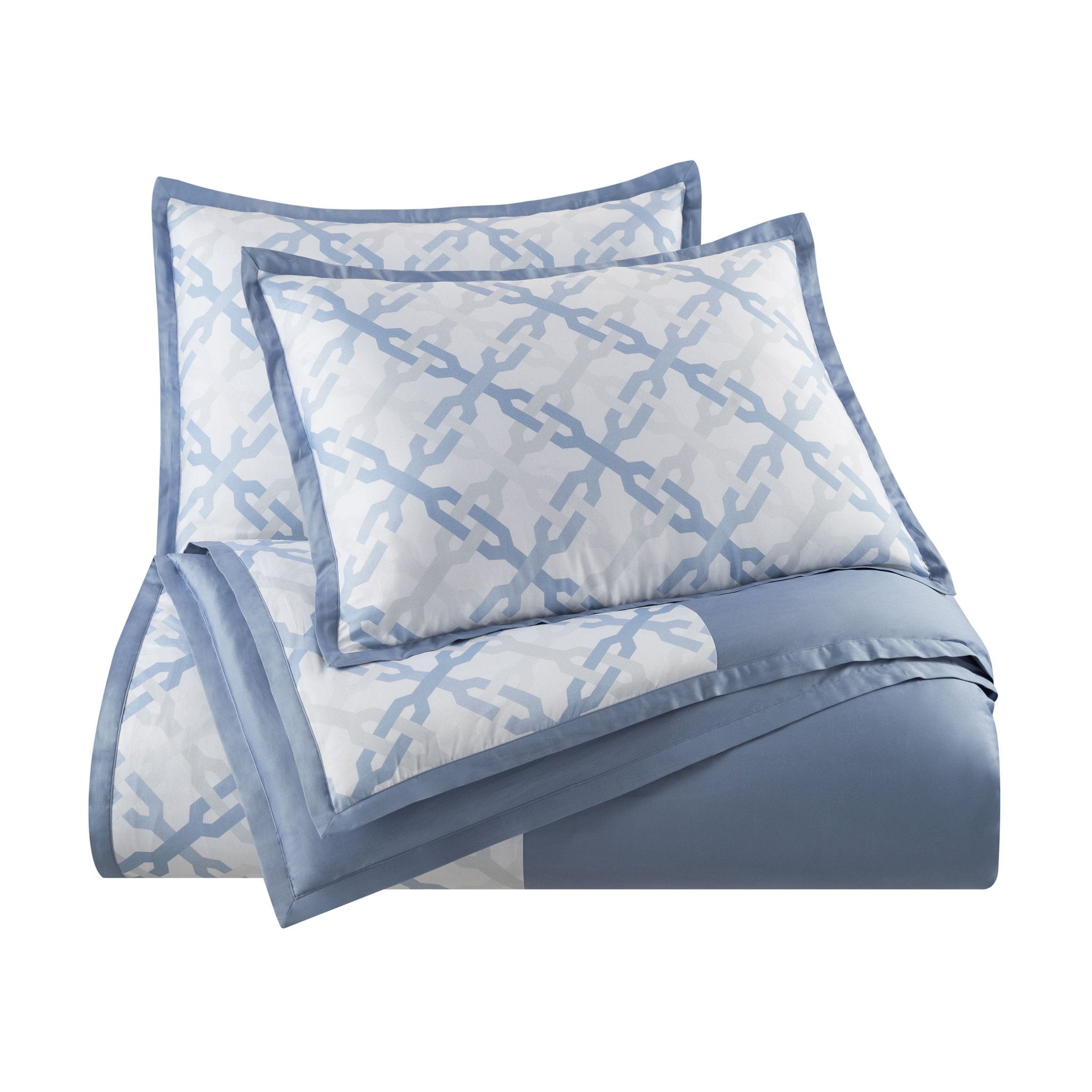 Blue and white patterned comforter set on a white background