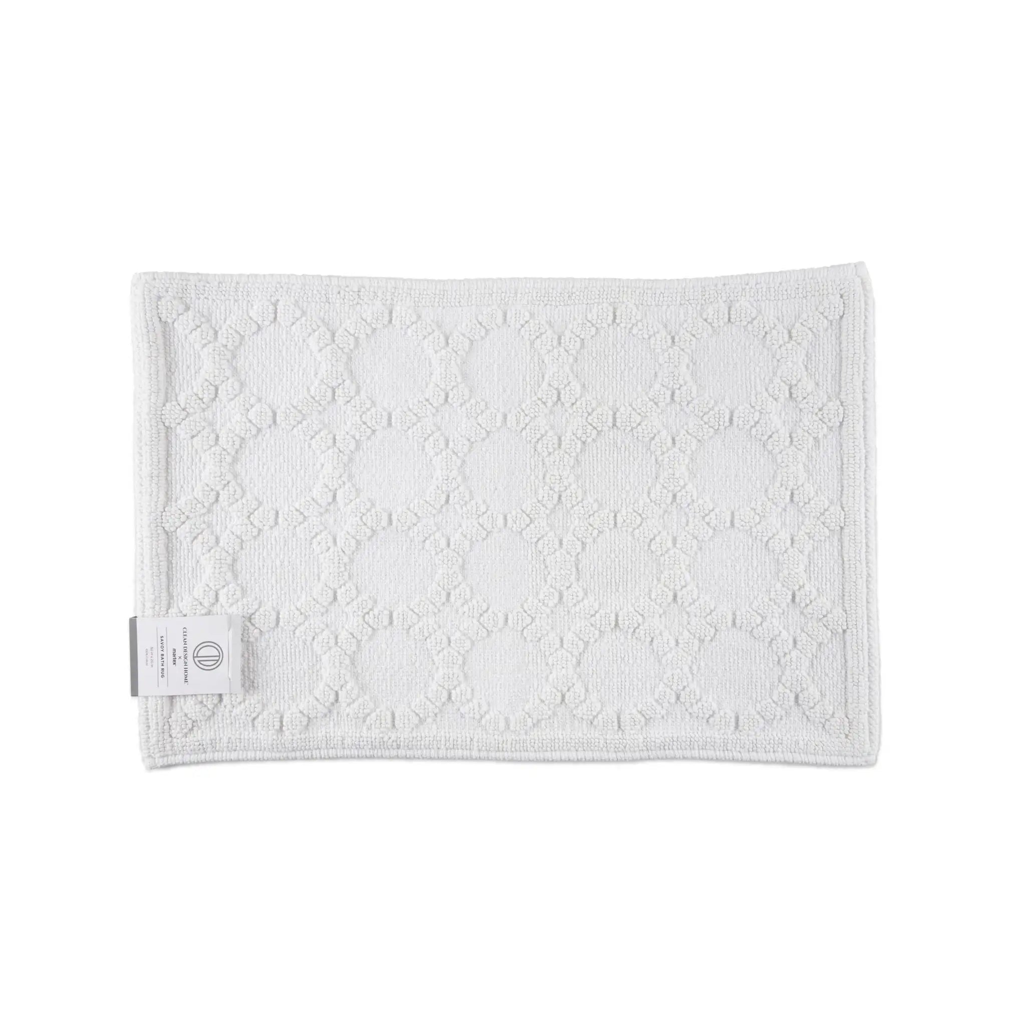 A white textured bath rug, shown on a plain white background.