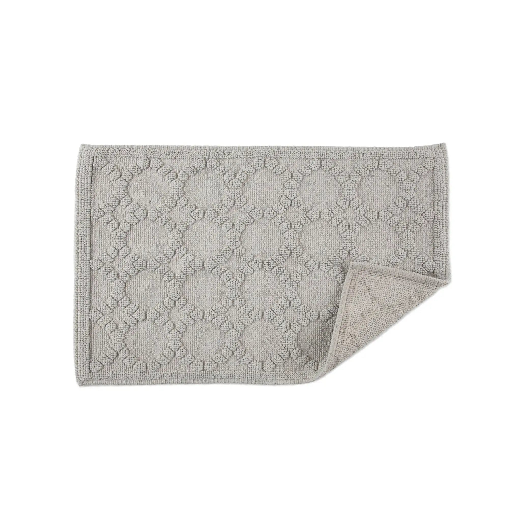 Gray textured bath rug on a white background