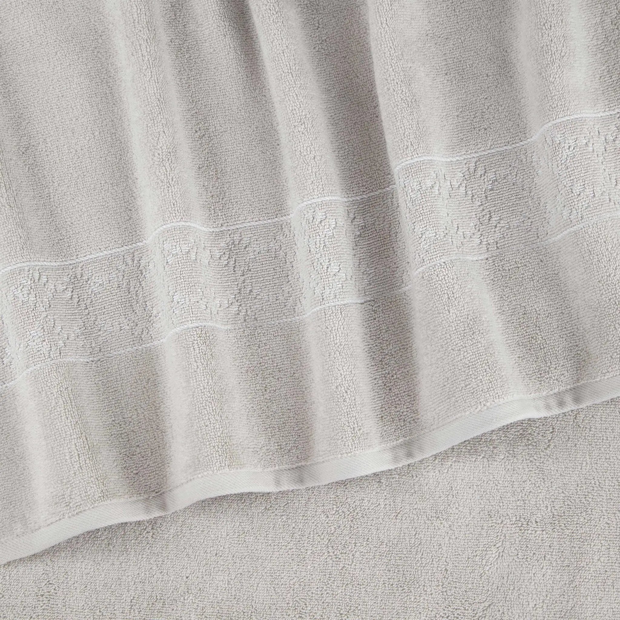 Close-up of a textured gray towel with embroidered details