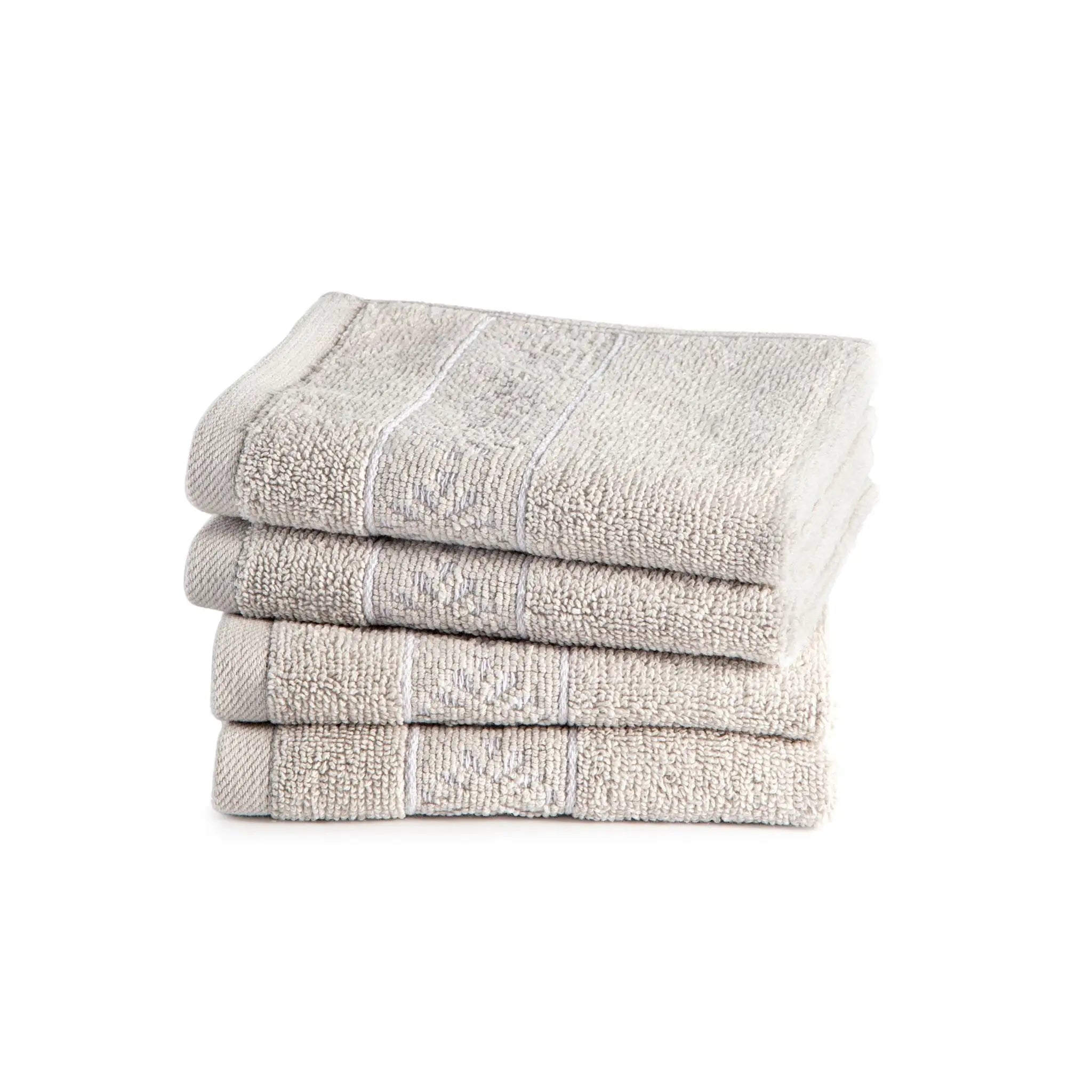 Stack of four grey folded washcloths on a white background