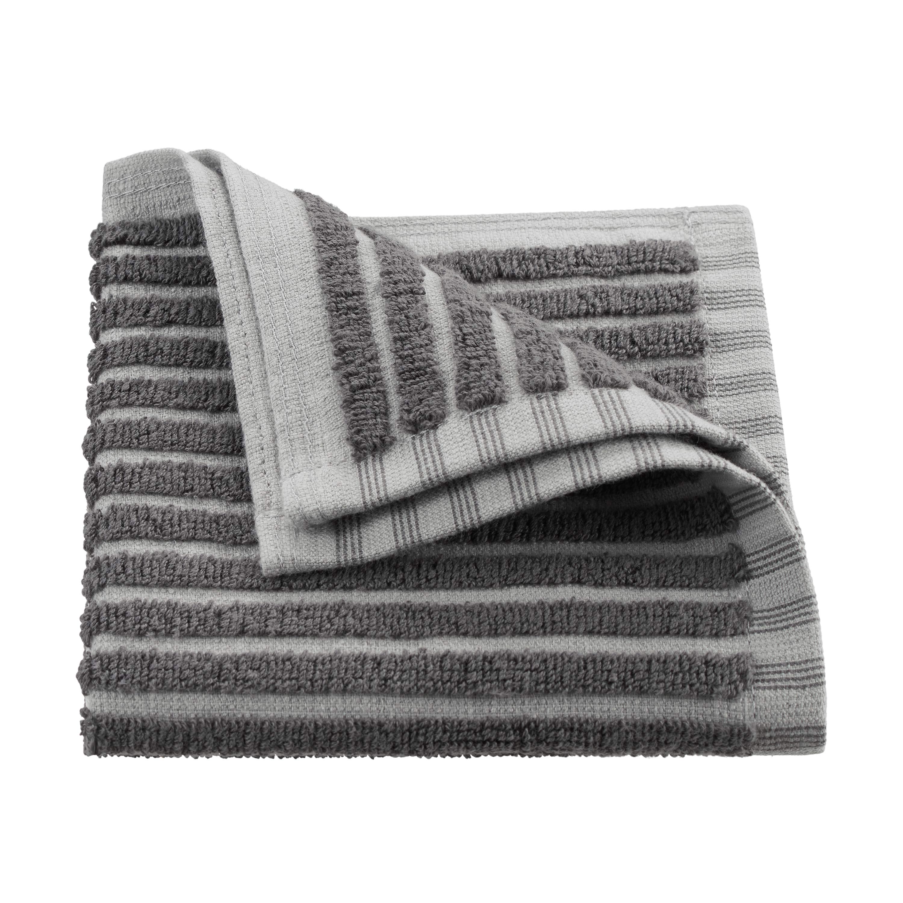 Gray towel with sculpted stripes, featuring a textured design and a folded corner.