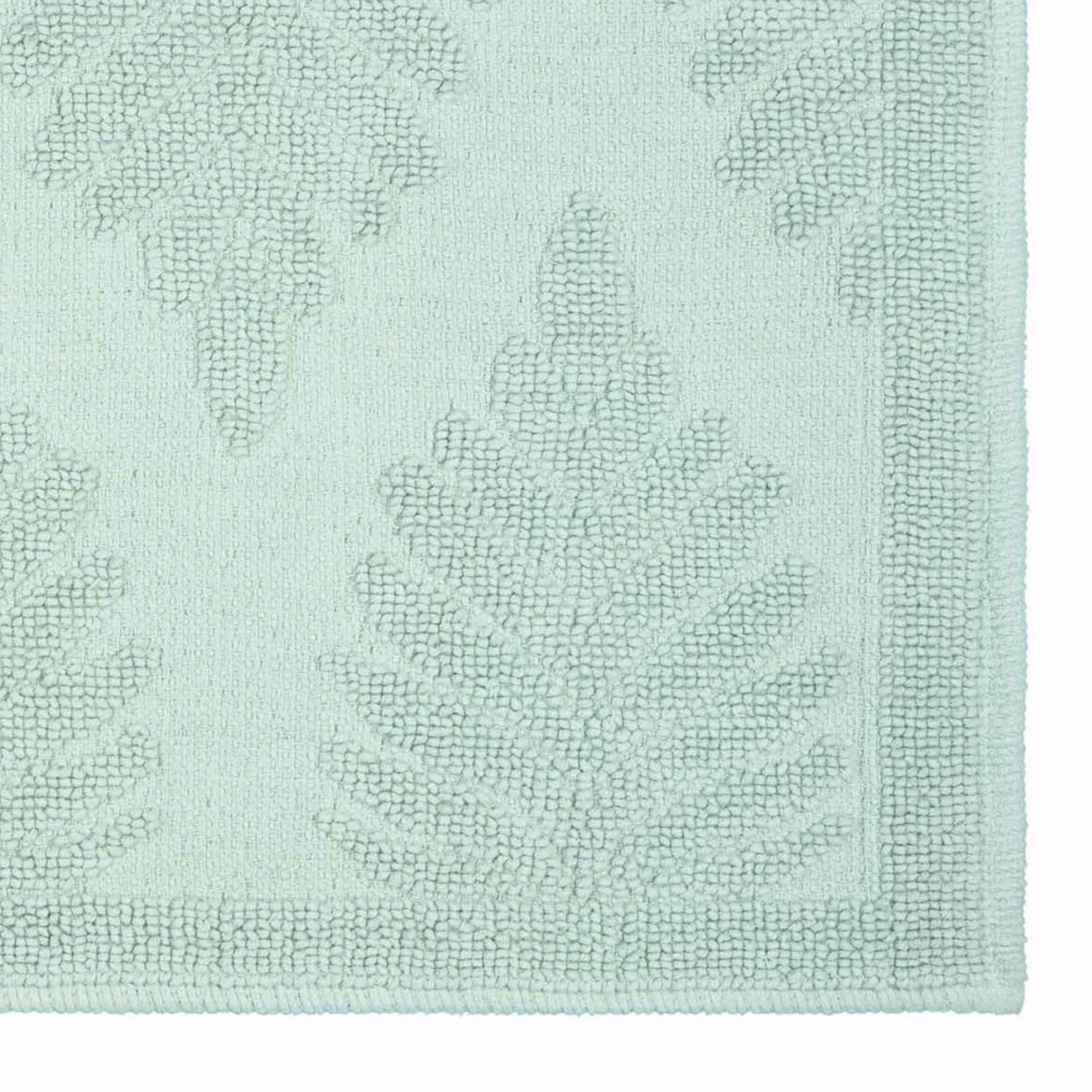 Light green bath rug featuring a fern ogee pattern with textured detailing and a bordered edge.