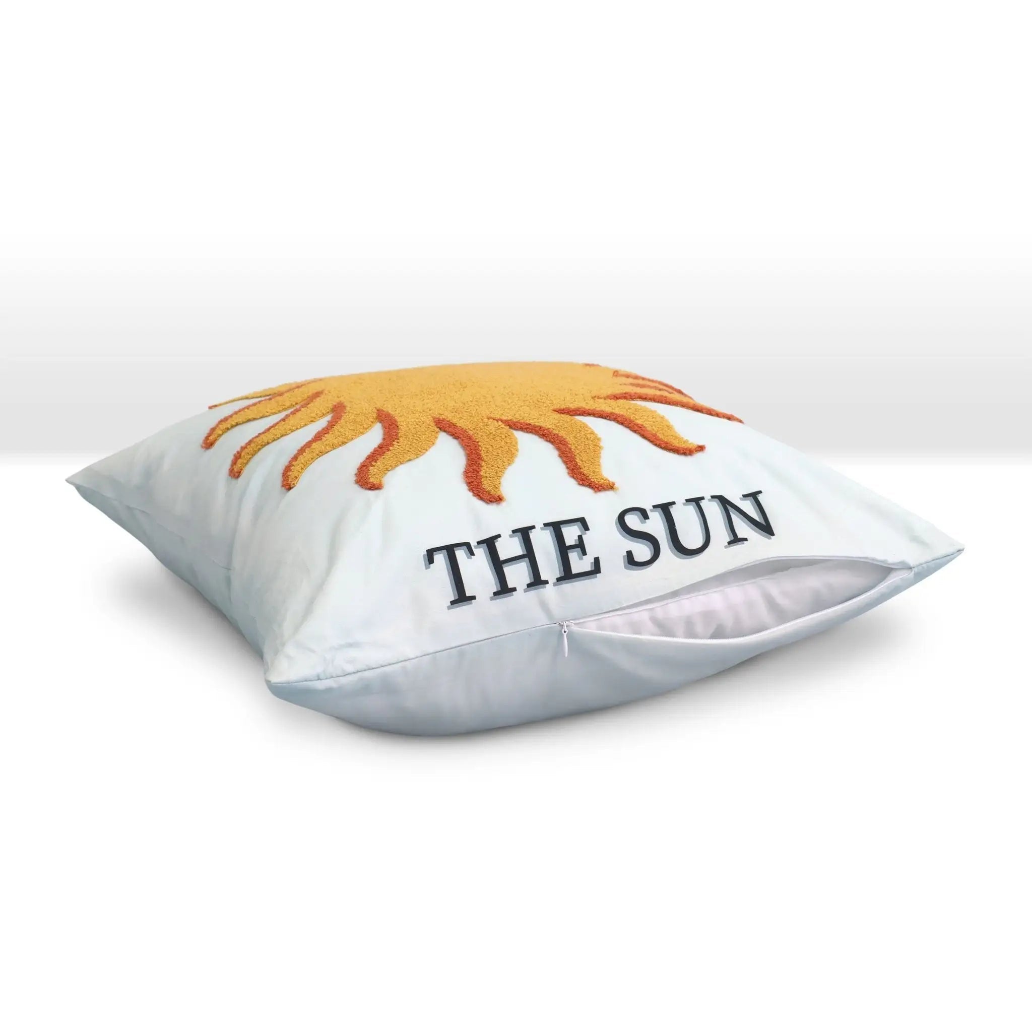 Pillow with a sun design and 'THE SUN' text on a white background