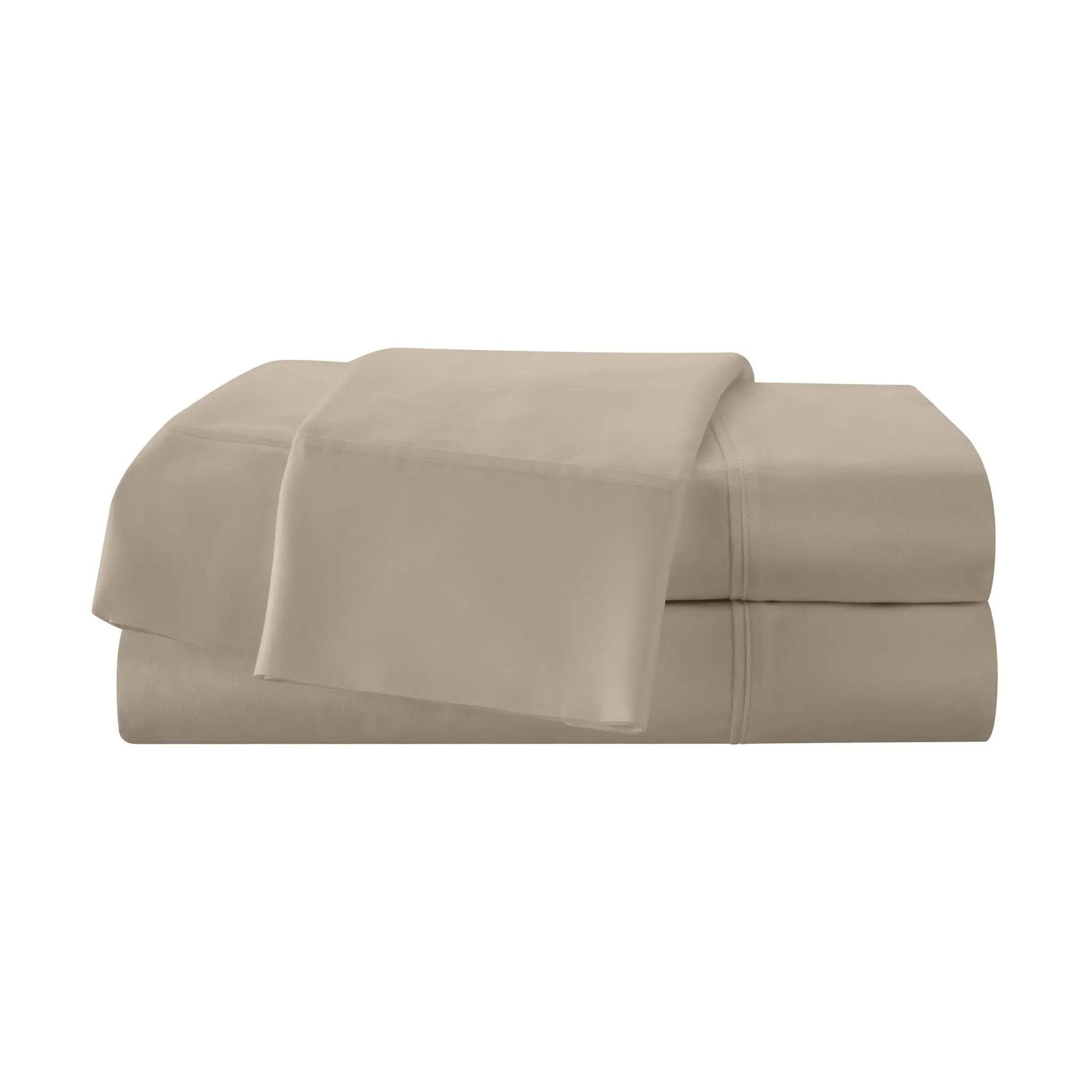 Folded beige bed sheets on a white background