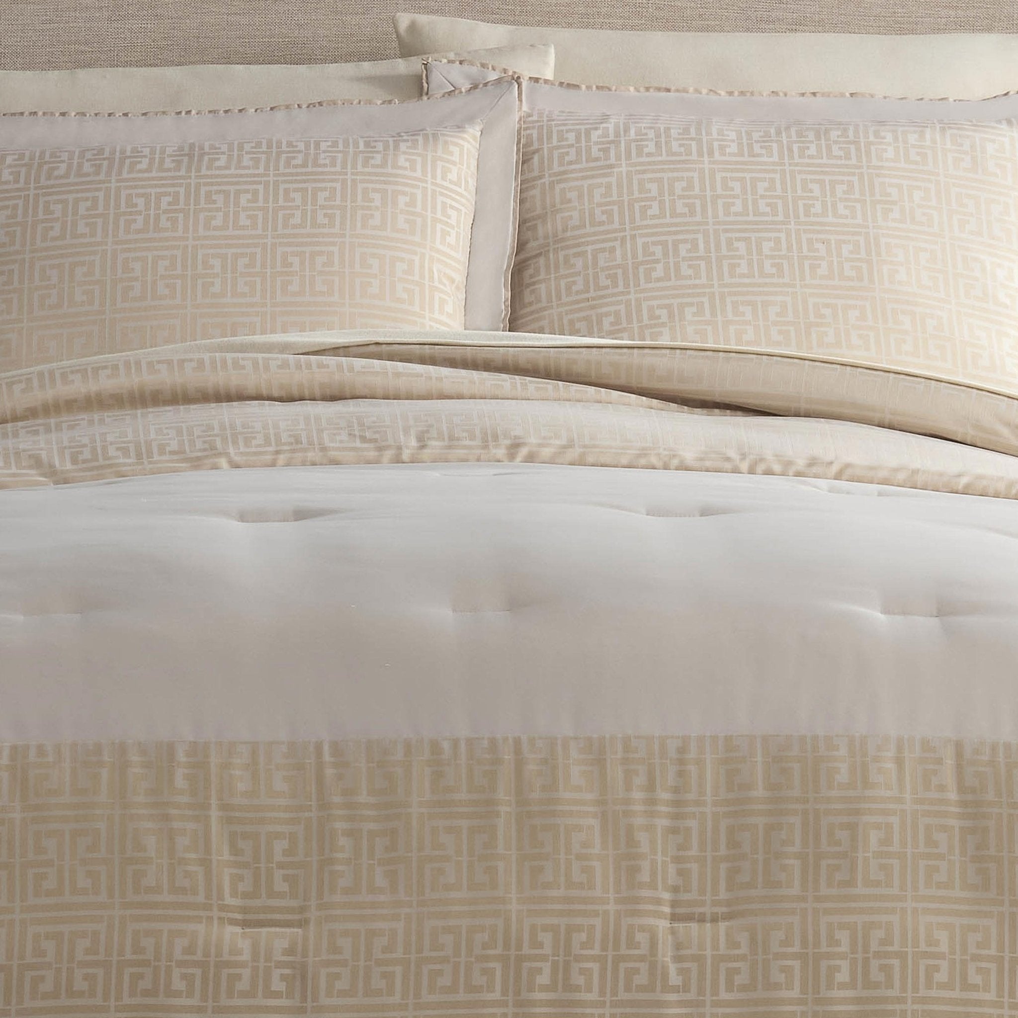 Neatly made bed with beige patterned bedding