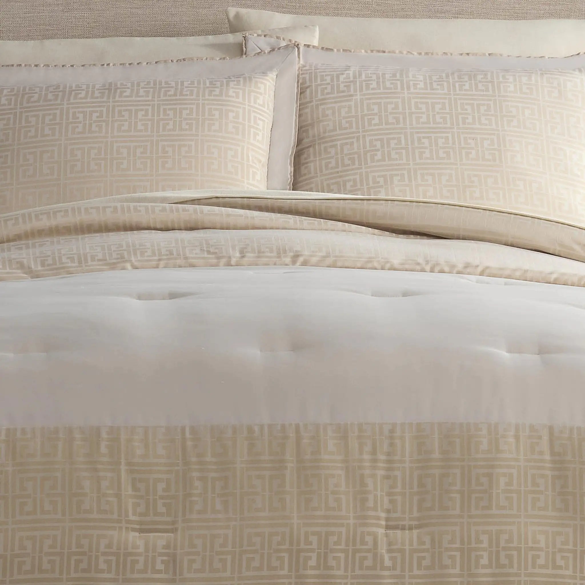 Beige comforter set featuring a tufted comforter with a Greek key pattern border and matching patterned pillow shams.