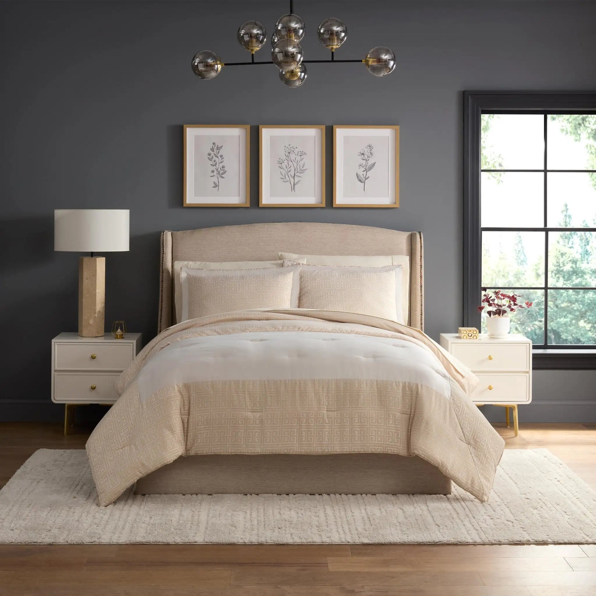 Neatly made bed in a bedroom with beige comforter set.