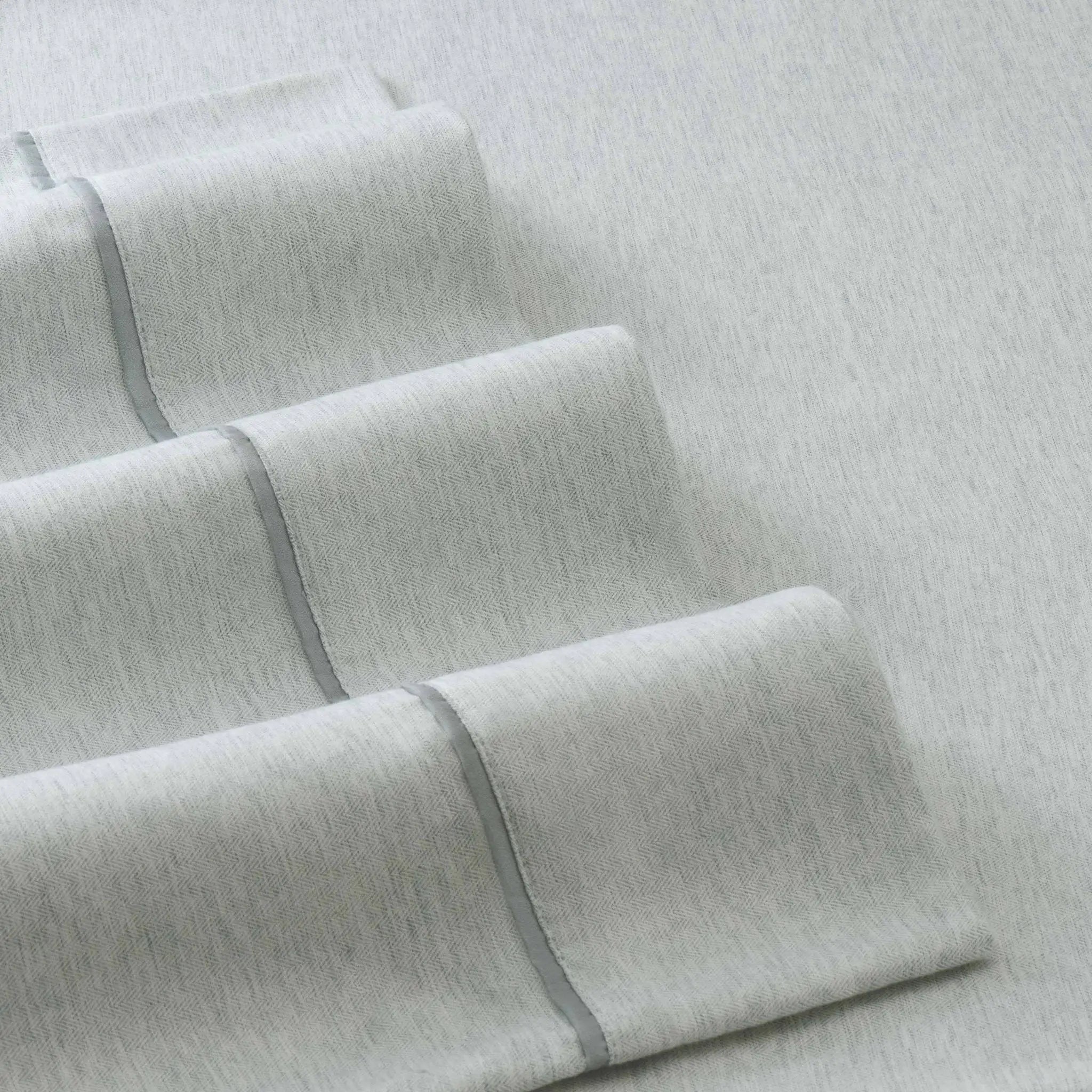 Close-up of light gray fabric with a subtle pattern on a matching background