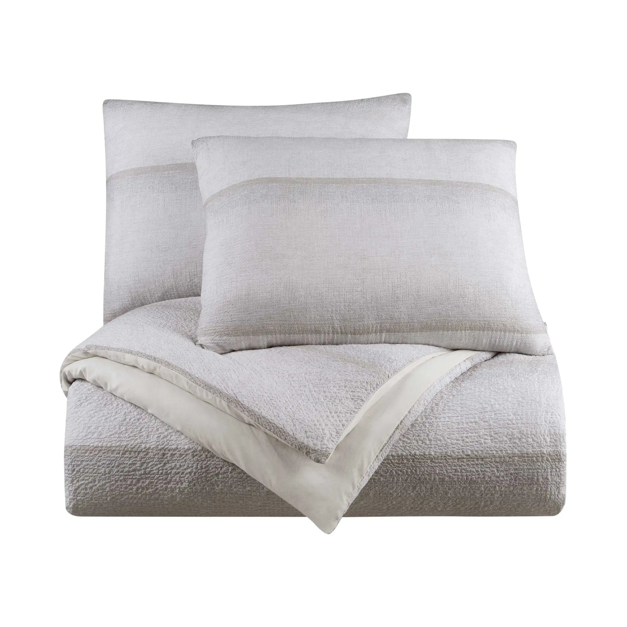 A light gray textured bedding set including a folded comforter and pillow shams, arranged on a plain white background.