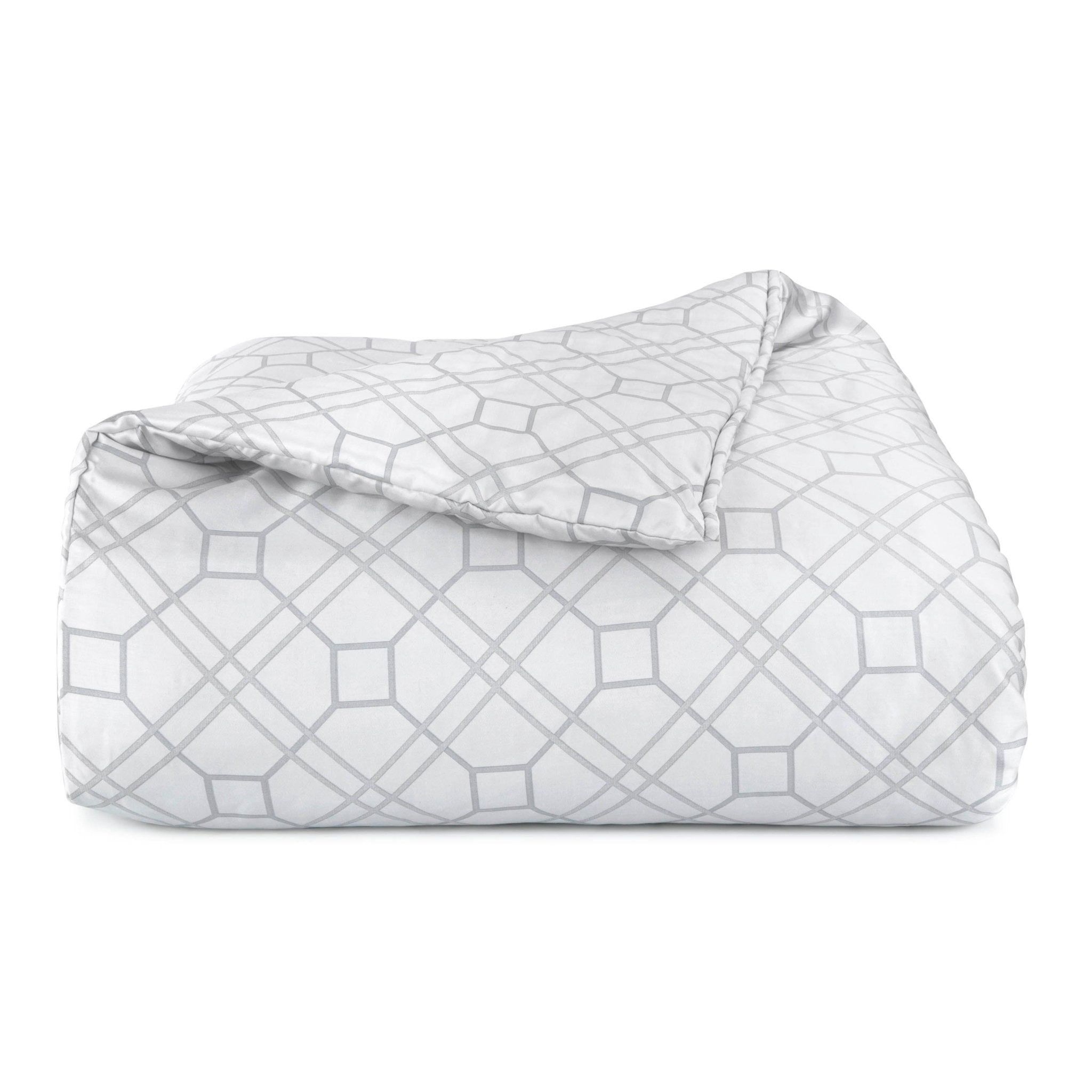 Folded comforter with geometric pattern on a white background