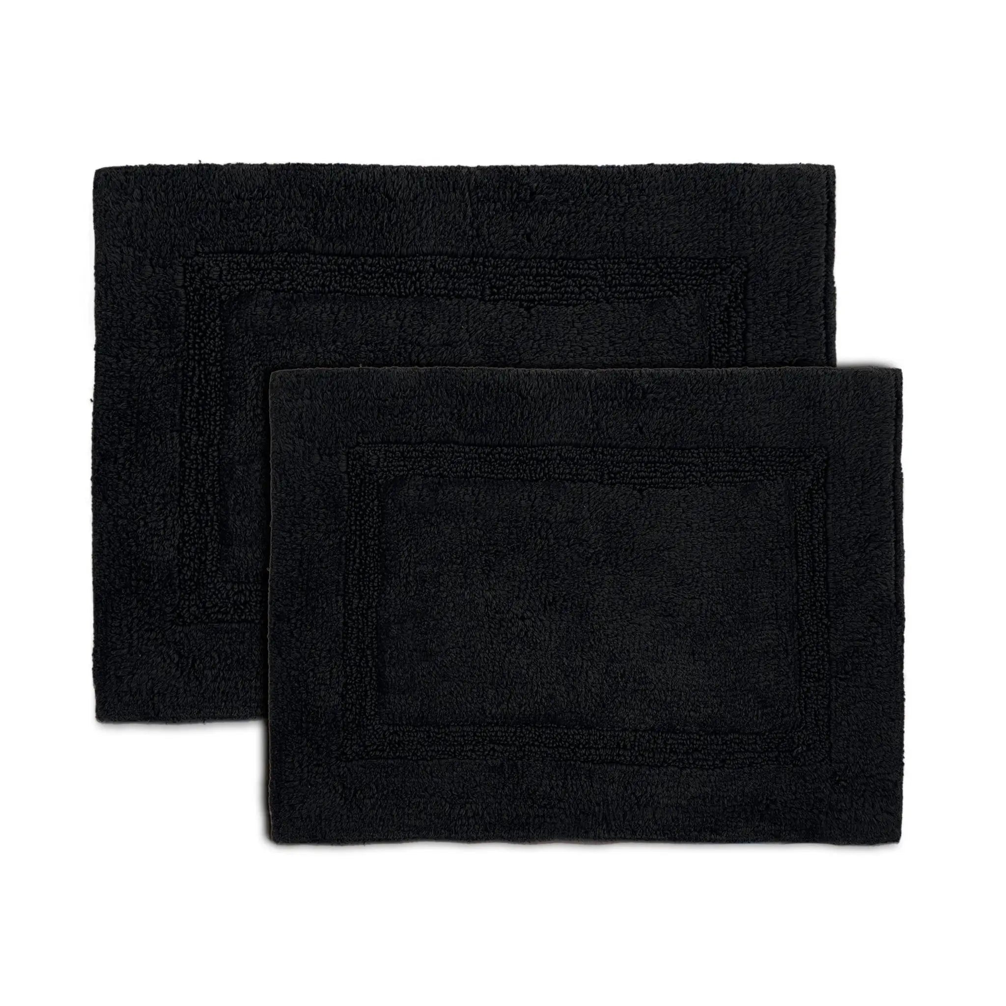 Two black bath rugs on a white background