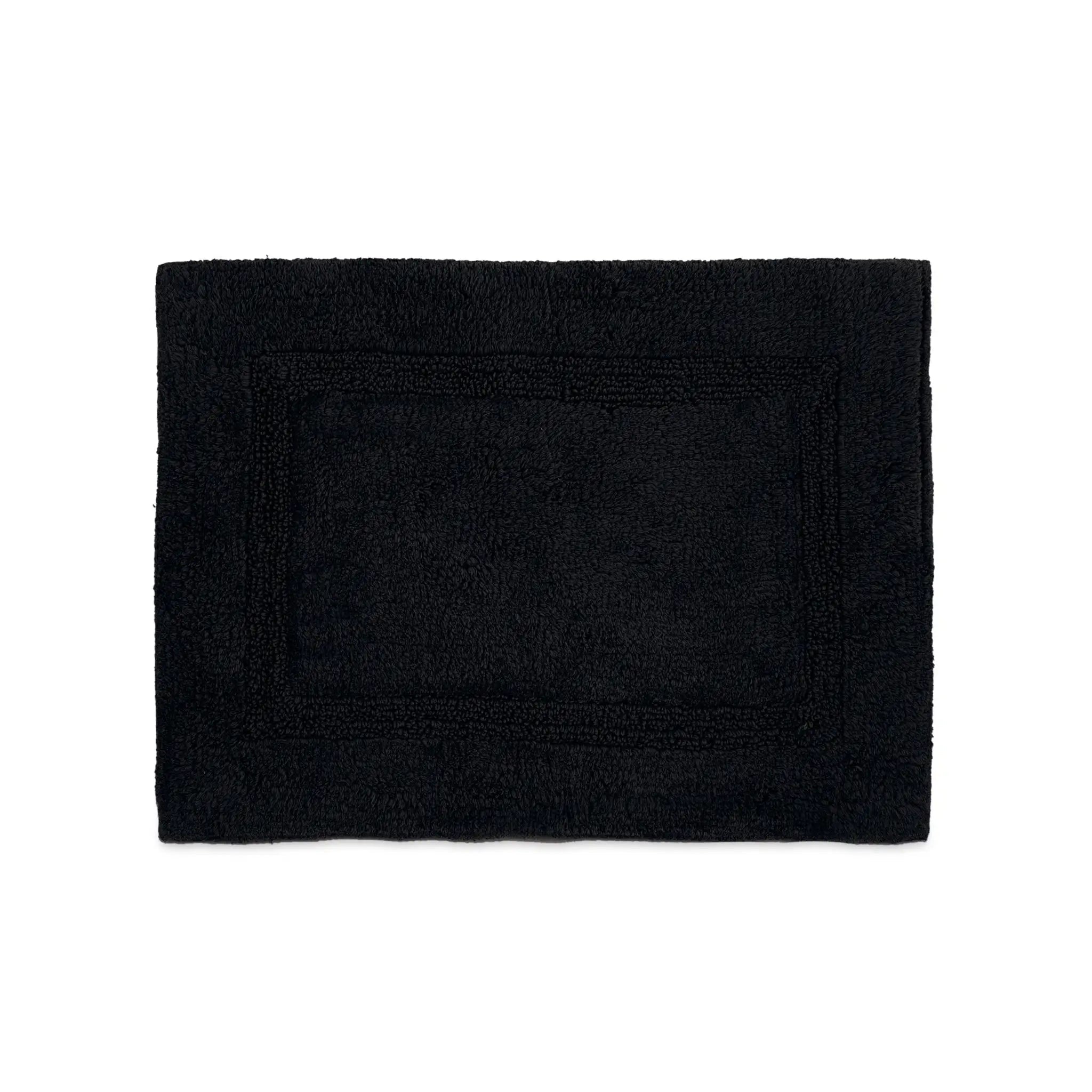 A black rectangular bath rug with a raised border, flat against a solid white background.