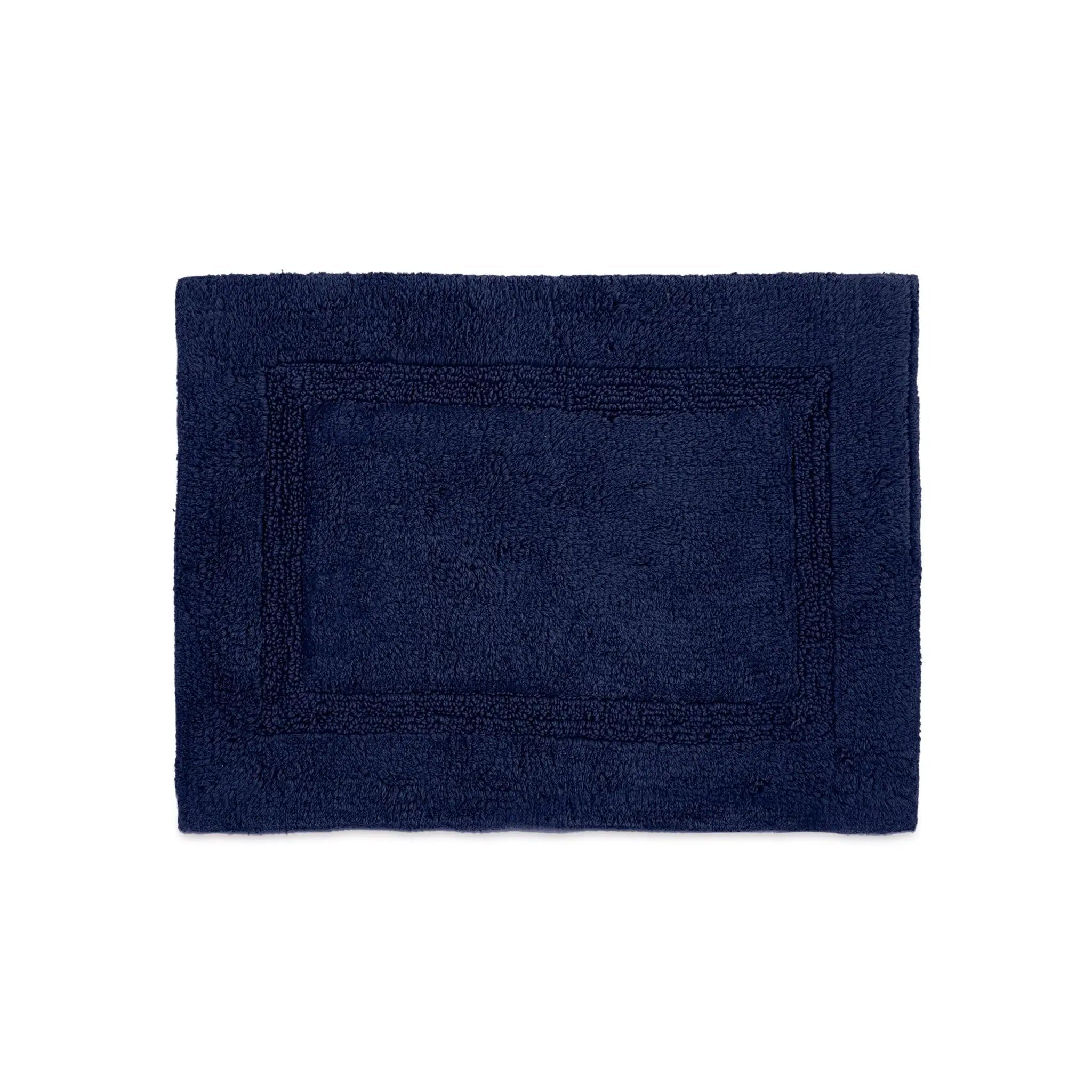 A rectangular estate blue bath rug with a raised border, shown flat against a solid white background.